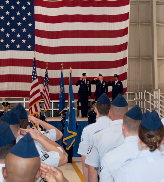 Airmen from the 71st Medical Group salute during the playing of the national anthem at the 71st Medical Group change of command ceremony June 16 at Vance Air Force Base, Oklahoma. Col. Kirsten Benford assumed command of the group from Col. David Chiesa. (U.S. Air Force photo/Staff Sgt. Nancy Falcon)