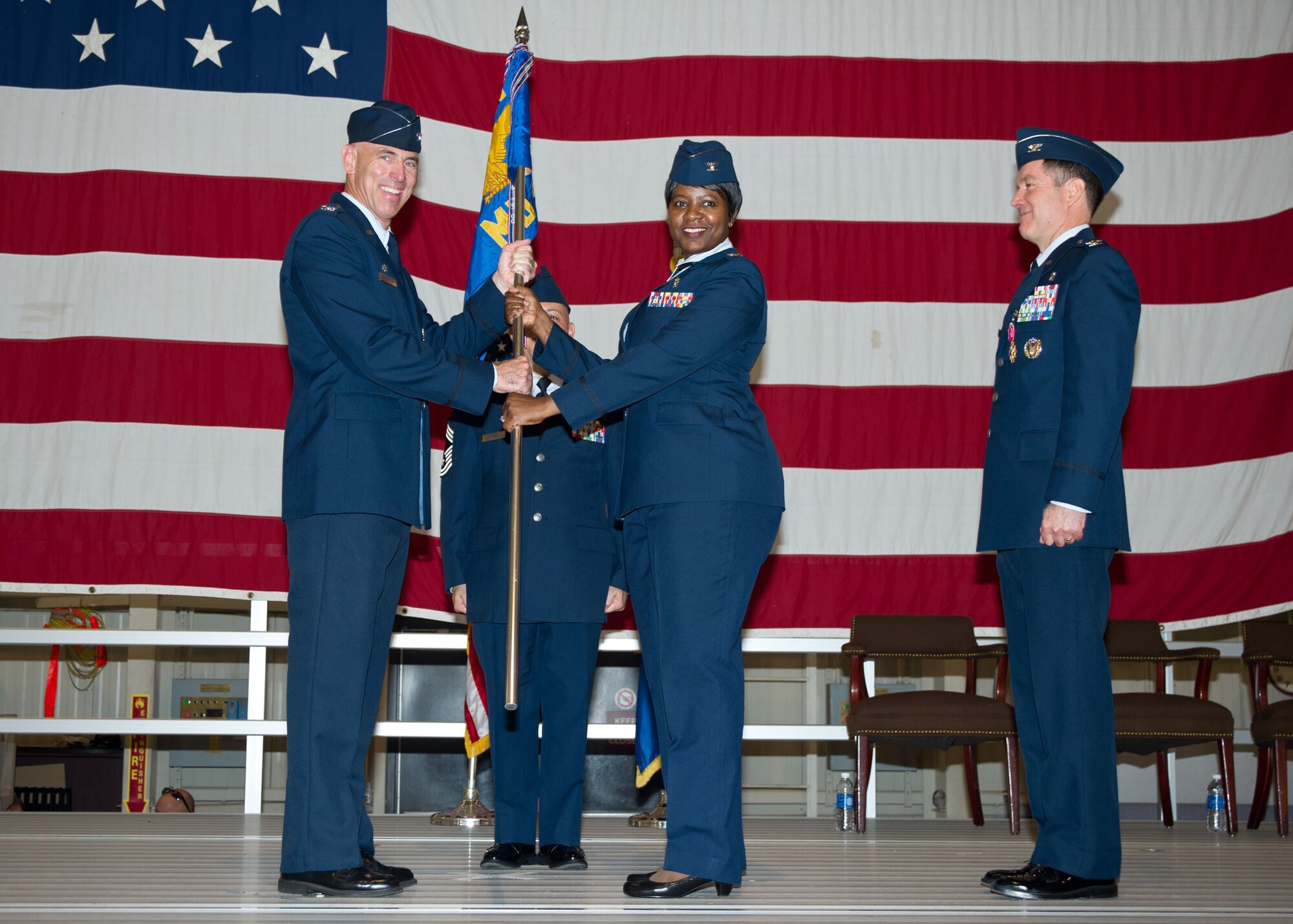 Col. Kirsten Benford accepts the 71st Medical Group guidon from Col. Clark Quinn, the 71st Flying Training Wing commander, during a change of command ceremony June 16 at Vance Air Force Base, Oklahoma. Benford was the commander at the 99th Inpatient Operations Squadron, 99th Medical Group, Nellis Air Force Base, Nevada. (U.S. Air Force photo/Terry Wasson)