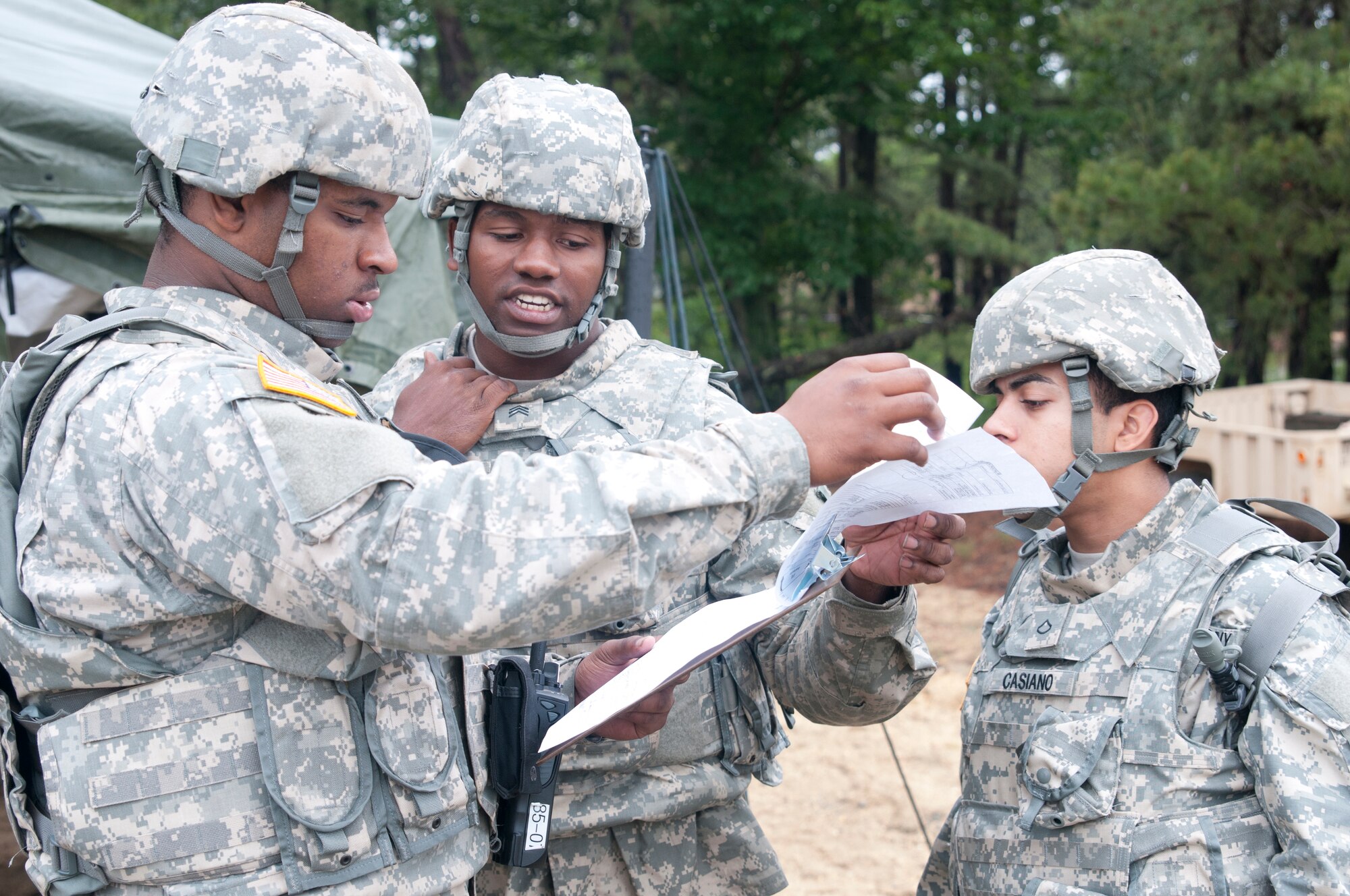 Army Reserve transportation management coordinator Pfc. Aikeem Johnson, Sgt. Miguel Sellers, and Pfc. Luis Casiano with the 385th Movement Control Team out of Fort Brag, North Carolina review trip tickets for convoys leaving the Quartermaster Liquid Logistic Exercise (QLLEX) Forward Operation Base in Joint Base McGuire-Dix-Lakehurst, New Jersey on June 09.