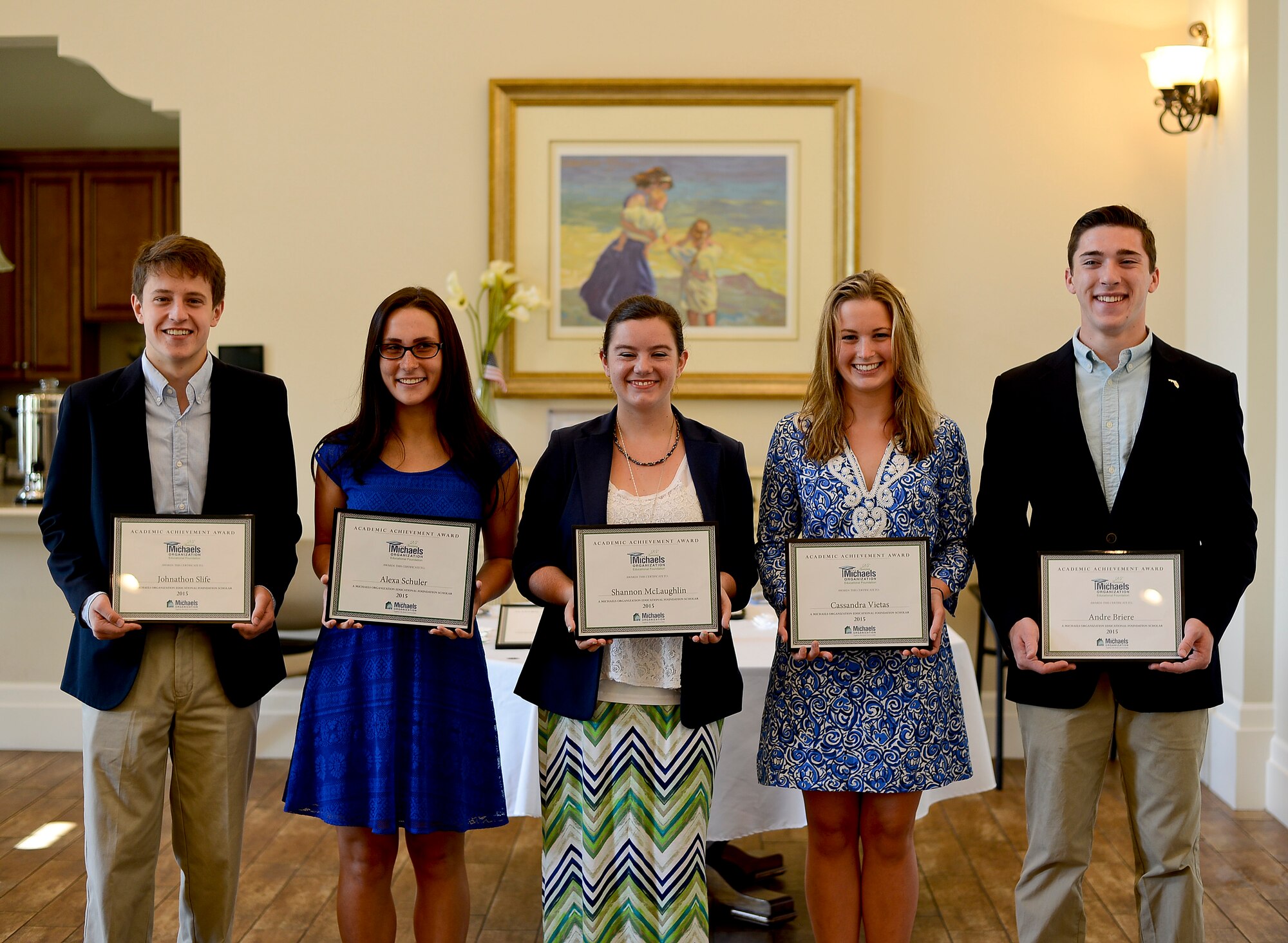 Five of the six scholarship recipients pose for a photo upon being awarded their scholarship at MacDill Air Force Base, Fla., June 17, 2015. Military dependents who reside in military housing communities owned by The Michaels Organization are eligible to apply and receive a grant, ranging from $500 to $5,000. (U.S. Air Force photo by Senior Airman Melanie Bulow-Gonterman/Released)