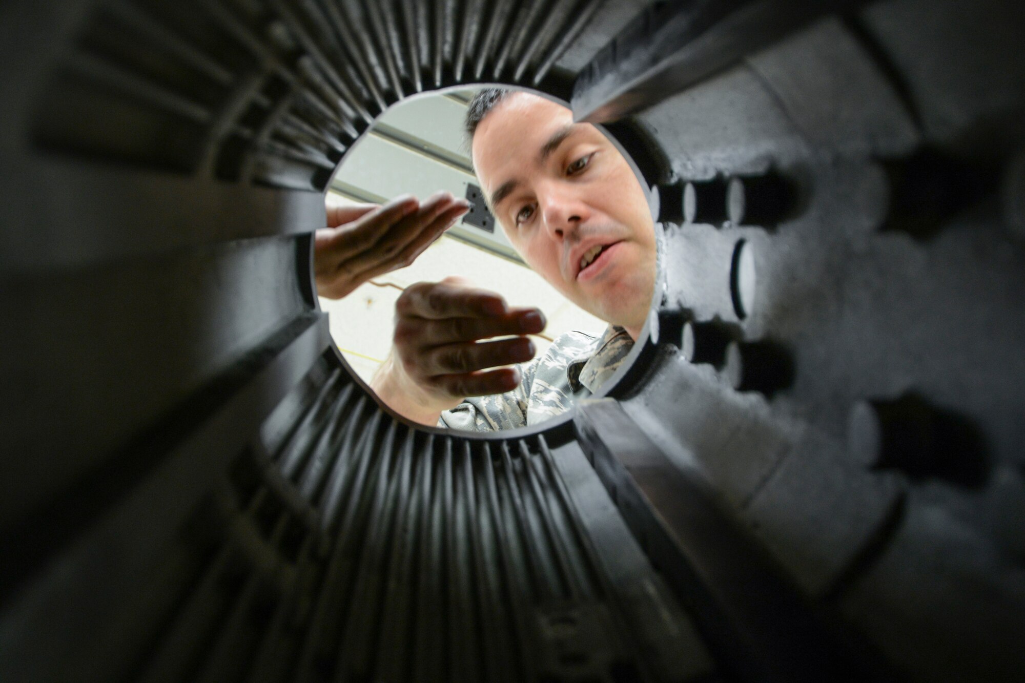 U.S. Air Force Senior Airman Matthew Ringer, a 354th Maintenance Squadron electronic warfare technician, inspects the inside of an electronic attack pod for E36 deicer intrusion May 26, 2015, at Eielson Air Force Base, Alaska. This is the second year that technicians fully separated and inspected pieces of the pod to keep them well maintained. (U.S. Air Force photo by Senior Airman Ashley Nicole Taylor/Released)