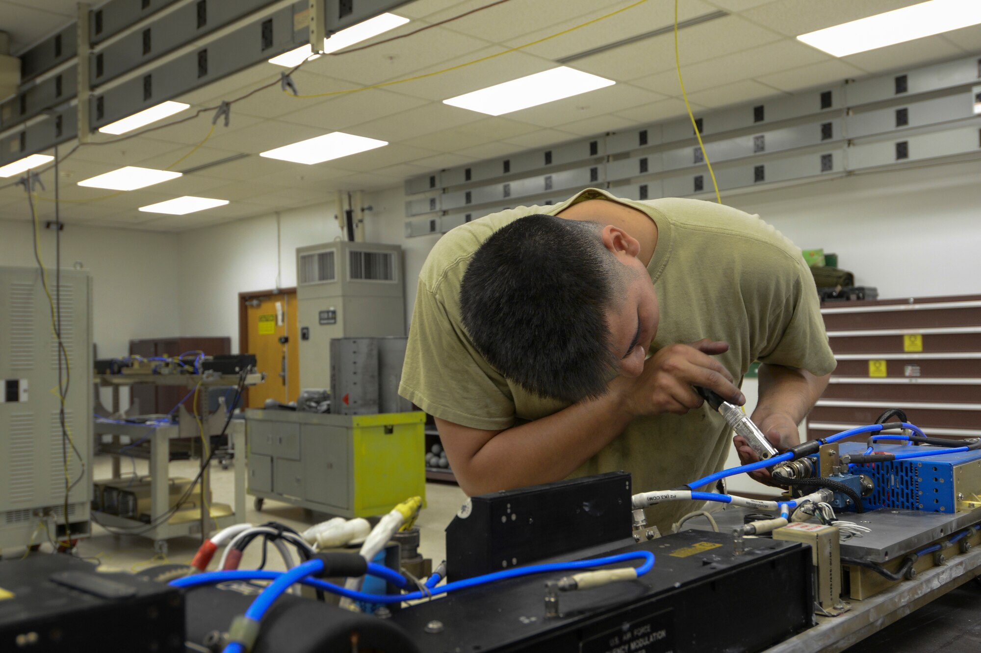 U.S. Air Force Airman 1st Class Anthony Davis, a 354th Maintenance Squadron electronic warfare systems technician, quality checks an electronic attack pod May 26, 2015, at Eielson Air Force Base, Alaska. Each pod is essential to exercises such as RED FLAG-Alaska. (U.S. Air Force photo by Senior Airman Ashley Nicole Taylor/Released)