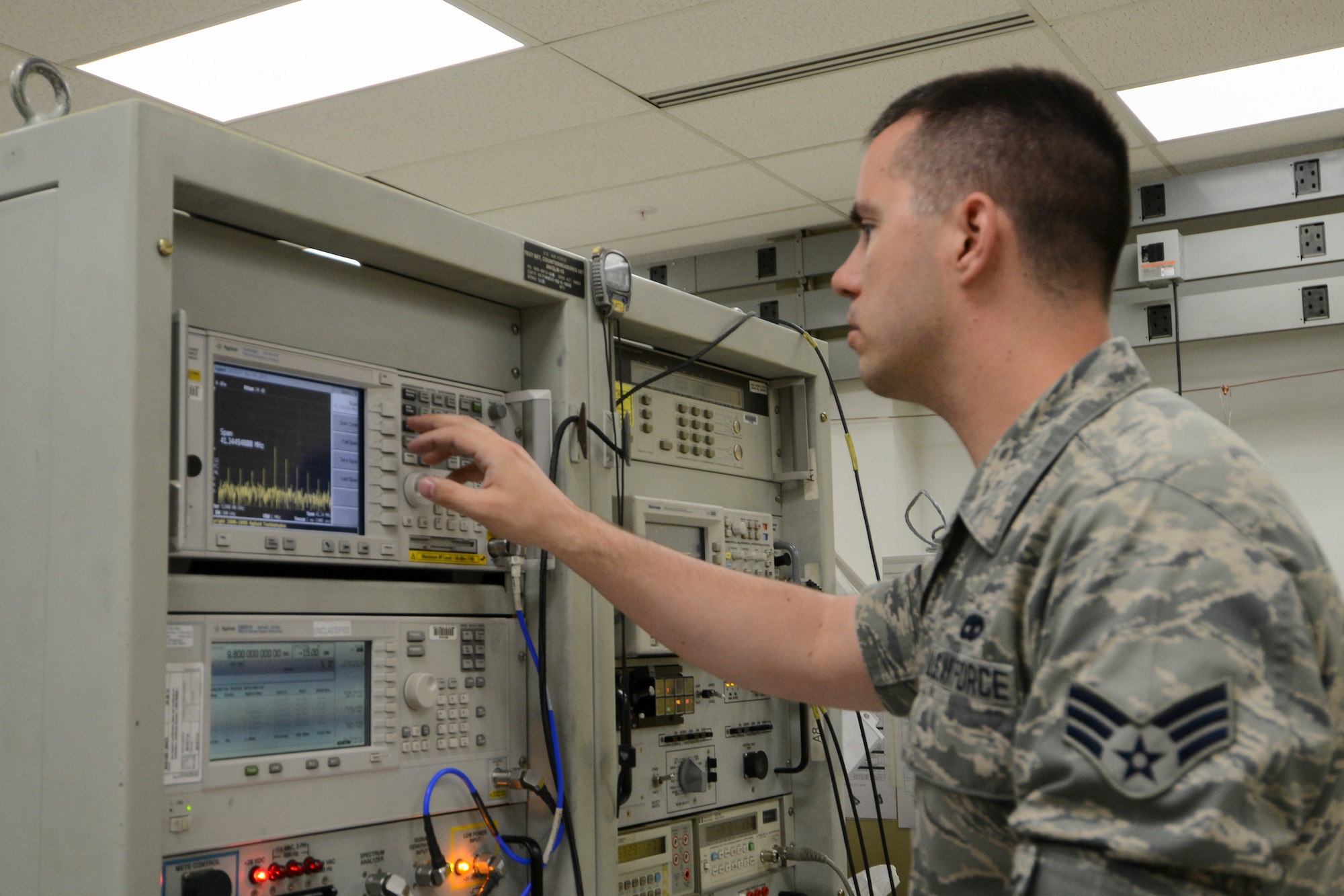 U.S. Air Force Senior Airman Matthew Ringer, a 354th Maintenance Squadron electronic warfare technician, sets up a signal to test an electronic attack pod’s response May 26, 2015, at Eielson Air Force Base, Alaska. Technicians calibrate and program the pods which simulate enemy threats during combat sorties. (U.S. Air Force photo by Senior Airman Ashley Nicole Taylor/Released)