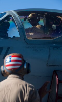 U.S. Marine Corps Lance Cpl. Jonathan L. Vega, foreground, a power liner with Marine Tactical Electronic Warfare Squadron (VMAQ) 2, 2nd Marine Aircraft Wing gives instructions to Staff Sgt. Alvin Ayers, also a power liner with VMAQ-2, prior to a training flight during Exercise Northern Edge 15 at Eielson Air Force Base, Alaska, June 15, 2015. Northern Edge is Alaska’s premier joint training exercise designed to practice operations, techniques and procedures as well as enhance interoperability among the services. Thousands of participants from all services, Airmen, Soldiers, Sailors, Marines and Coast Guardsmen from active duty, Reserve and National Guard units are involved. (U.S. Marine Corps photo by Cpl. Suzanne Dickson/Released)