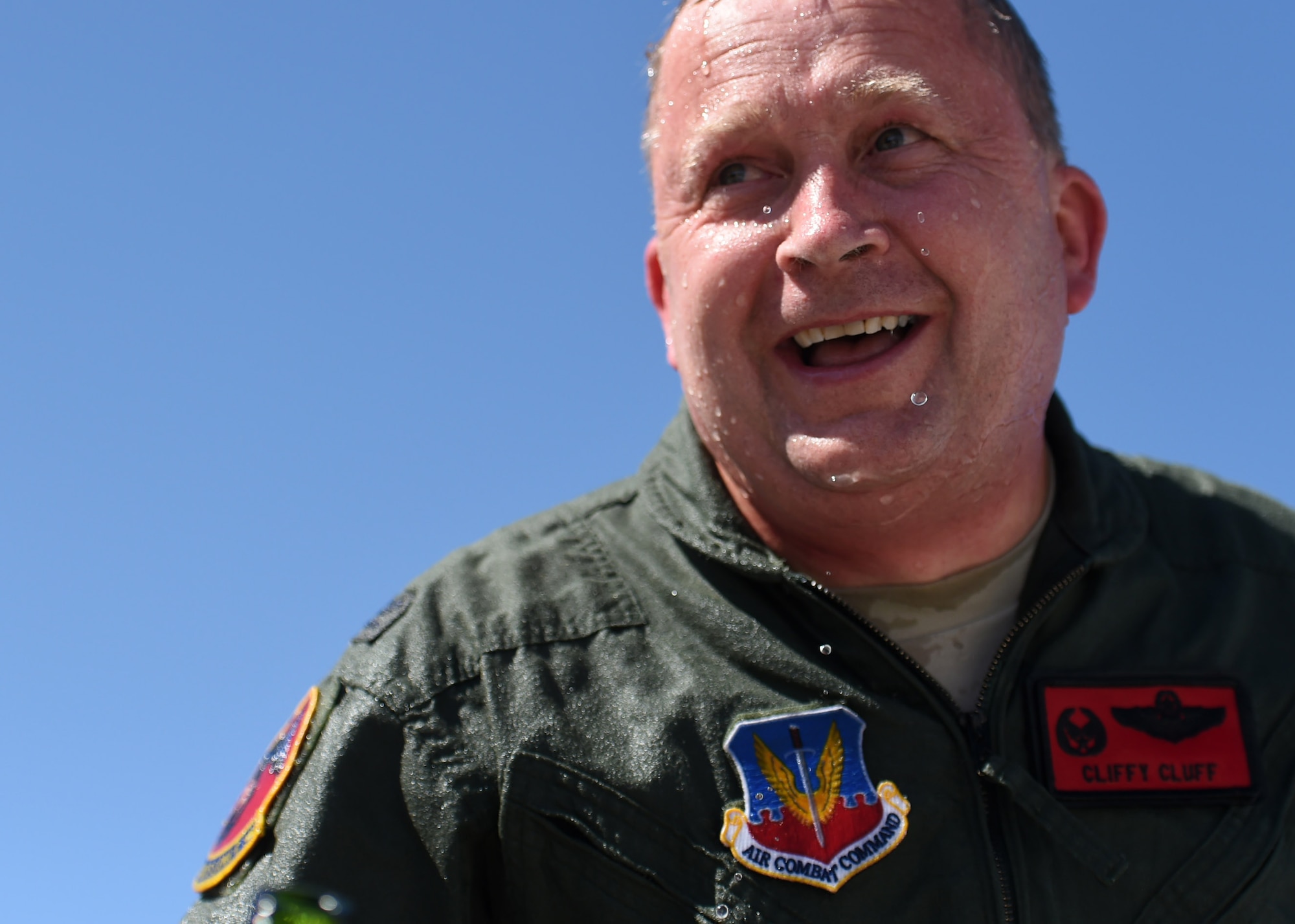 Col. James Cluff, 432nd Wing/432nd Air Expeditionary Wing commander, laughs after being hosed down by Team Creech Members following his final flight with the wing May 28th, 2015 on Creech Air Force Base Nevada. The tradition of fini-flights can trace its roots back to the U.S. Army Air Force days of the World War II era. (U.S. Air Force photo by Tech. Sgt. Nadine Barclay/RELEASED)
