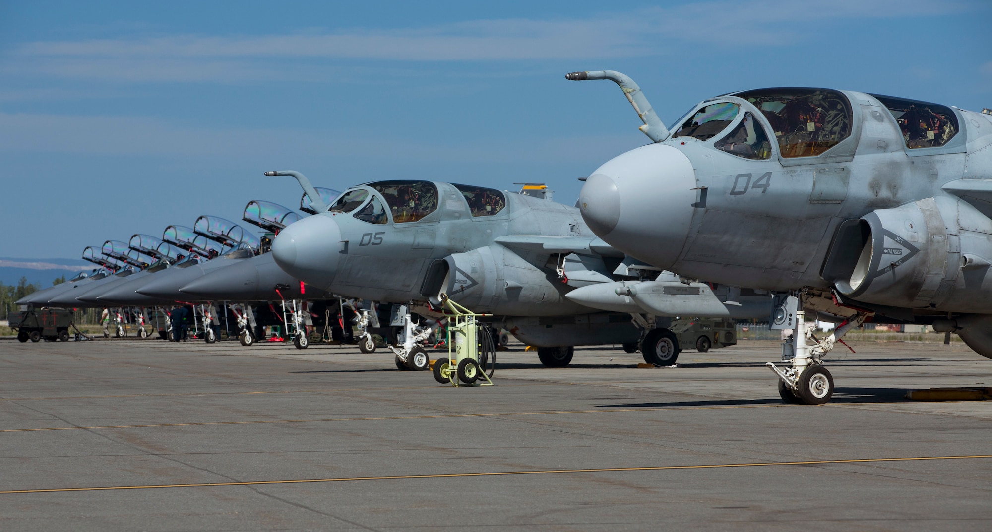 U.S. Marine Corps EA-6B Prowler aircrafts assigned to Marine Tactical Electronic Warfare Squadron 2, 2nd Marine Aircraft Wing and U.S. Air Force F-15E Strike Eagle aircrafts assigned to the 4th Fighter Wing, Seymour Johnson Air Force Base, North Carolina, sit on the flight line during Exercise Northern Edge 15 at Eielson Air Force Base, Alaska, June 15, 2015. Northern Edge is Alaska’s premier joint training exercise designed to practice operations, techniques and procedures as well as enhance interoperability among the services. Thousands of participants from all services, Airmen, Soldiers, Sailors, Marines and Coast Guardsmen from active duty, Reserve and National Guard units are involved. (U.S. Marine Corps photo by Cpl. Suzanne Dickson/Released)