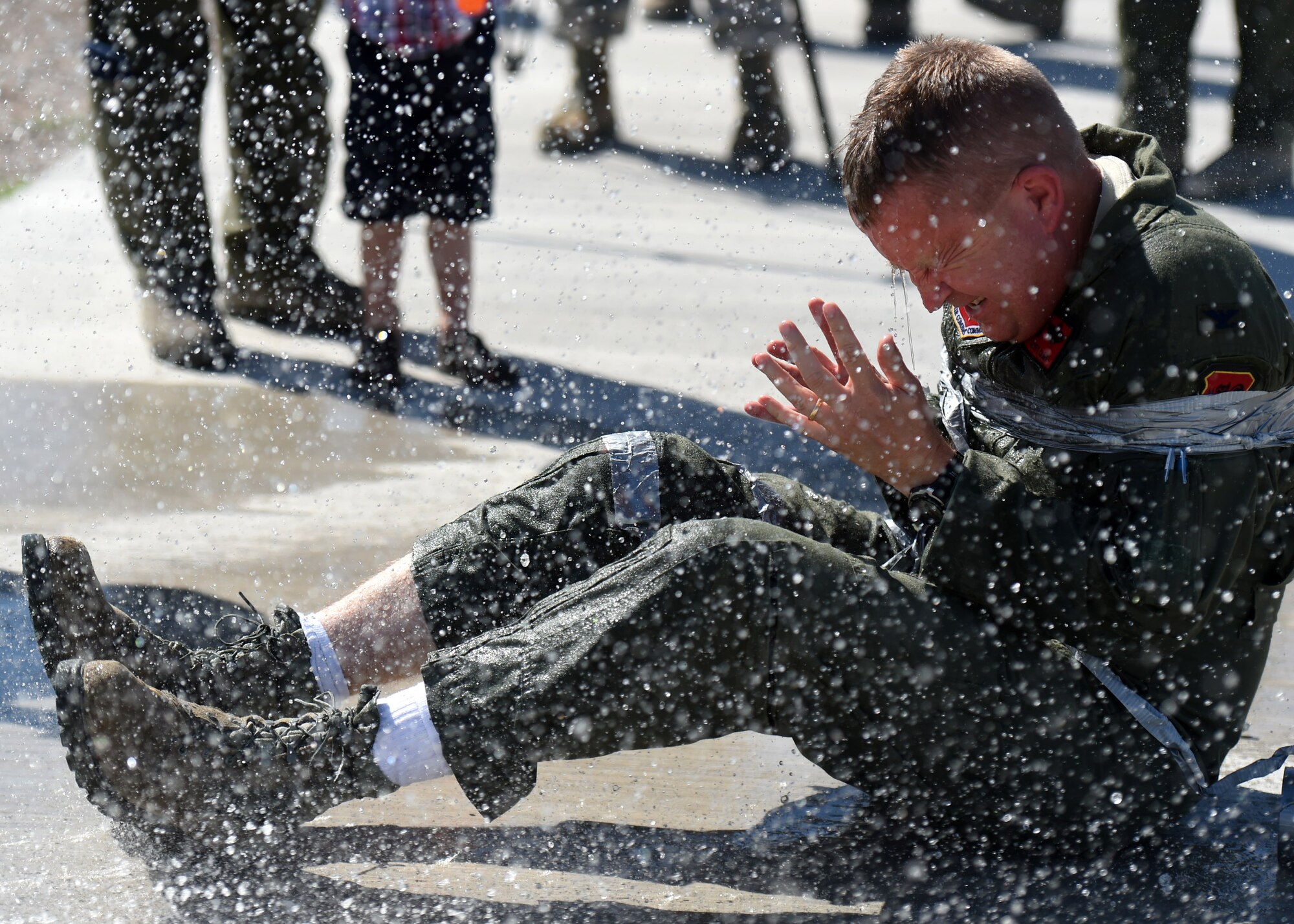 Col. James Cluff, 432nd Wing/432nd Air Expeditionary Wing commander, gets sprayed by his wife and fellow Airmen following his fini flight May 28th, 2015 on Creech Air Force Base Nevada. The fini-flight celebration has evolved over the years and now includes a toast and dowsing with water for the aircraft and aircrew. (U.S. Air Force photo by Tech. Sgt. Nadine Barclay/RELEASED)