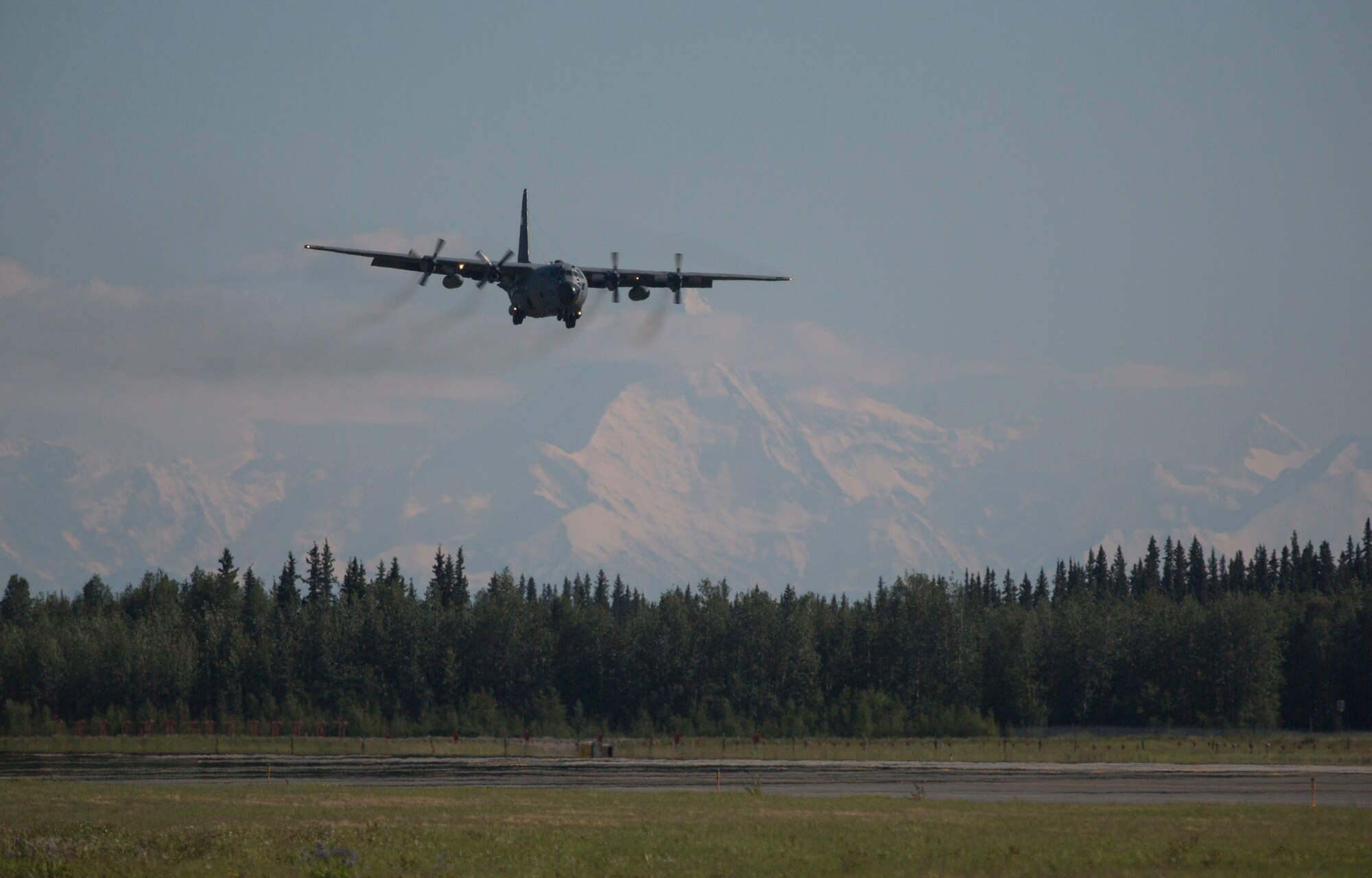 A U.S. Air Force C-130 Hercules assigned to the 374th Air Wing, Yakota, Japan, prepares to land during June 15, 2015, during Exercise Northern Edge 15 at Eielson Air Force Base, Alaska. Northern Edge 15 is Alaska’s premier joint training exercise designed to practice operations, techniques and procedures as well as enhance interoperability among the services. Thousands of participants from all the services, Airmen, Soldiers, Sailors, Marines and Coast Guardsmen from active duty, Reserve and National Guard units are involved. (U.S. Marine Corps photo by Staff Sgt. Jeffrey D. Anderson/ Released)