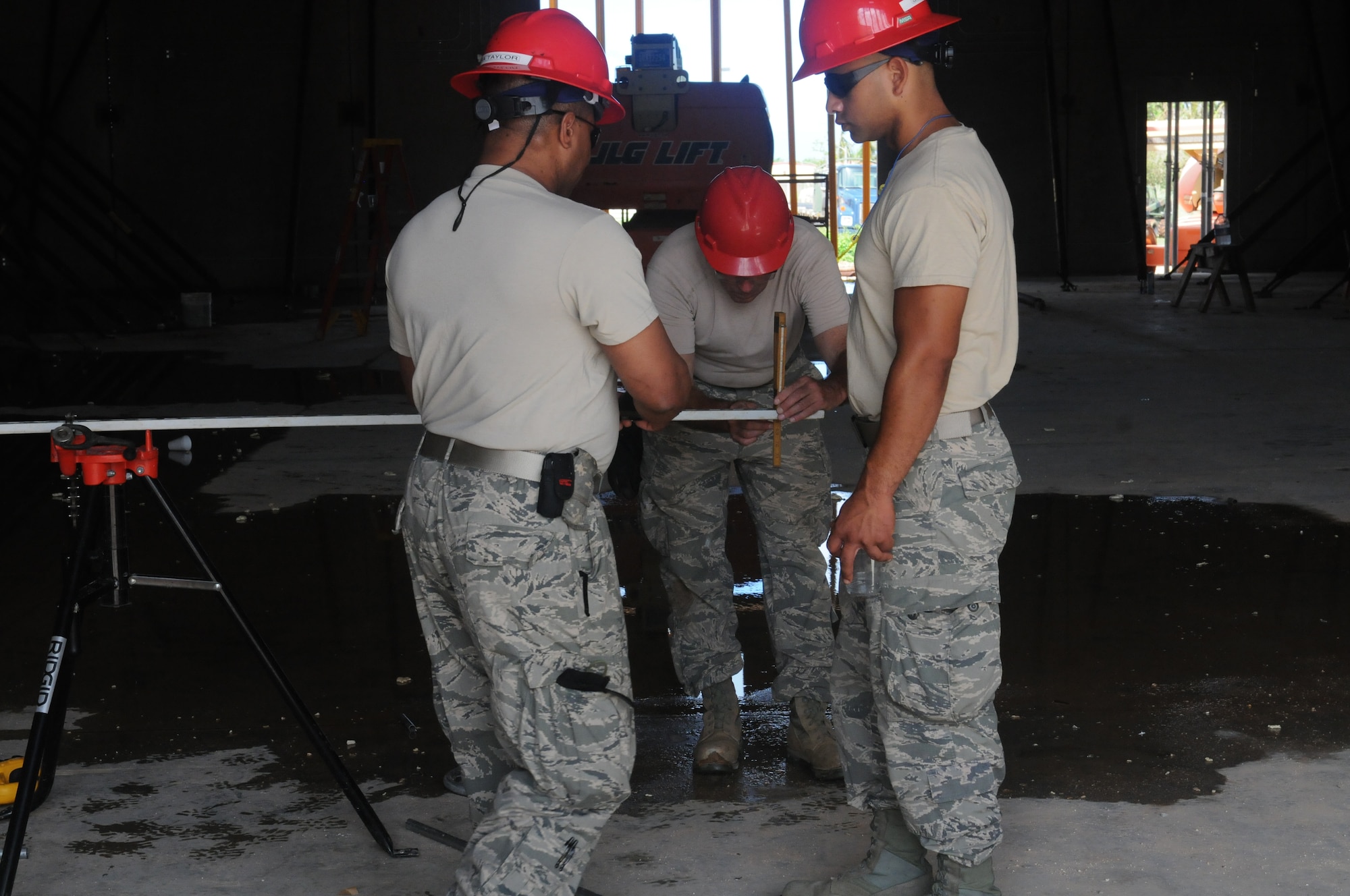 Airmen from the Virginia Air National Guard’s Virginia Beach-based 203rd RED HORSE Squadron and the 202nd RHS from Camp Blanding, Florida refine and train upon essential skills June 7, 2015 during a joint training mission to construct a Facilities Systems Training facility at Anderson Air Force Base, Guam. The Airmen are conducting training while building the FST facility under the Air National Guard’s Deployment for Training program. (U.S. Air National Guard photo by Tech. Sgt. Meghan Skrepenski/Released)
