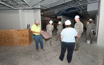 Louie Lamb (far left), Artesian Contracting project superintendent, describes properties of a ceiling tile that will be installed after renovations to the dining facility to Maj. Gen. Casey Blake, Office of the Assistant Secretary of the Air Force for Acquisition Deputy Assistant Secretary for Contracting, during the general’s visit June 16, 2015, at Moody Air Force Base, Ga. The contracting office coordinated construction of the dining facility and several other projects on Moody AFB. (U.S. Air Force photo by Staff Sgt. Eric Summers Jr./Released)