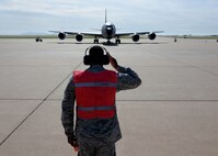 ALTUS AIR FORCE BASE, Okla. – U.S. Air Force Chief Master Sgt. James Powell, 97th Air Mobility Wing command chief, salutes a U.S. Air Force KC-135 Stratotanker refueling aircraft, operated by U.S. Air Force Col. Bill Spangenthal, 97th AMW commander, June 18, 2015. Spangenthal has served as the wing commander since June 2013 and will transfer command to U.S. Air Force Col. Todd Hohn will assume command June 26. (U.S. Air Force photo by Senior Airman Franklin R. Ramos/Released)