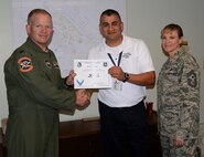 Jesus Valdez, center, 47th Civil Engineer Squadron housing management specialist, poses with Col. Darrell Judy, 47th Flying Training Wing vice commander, and Chief Master Sgt. Teresa Clapper, 47th FTW command chief, after accepting the XLer of the Week award here June 17, 2015. The XLer is a weekly award chosen by wing leadership and is presented to those who consistently make outstanding contributions to their unit and Laughlin. (U.S. Air Force photo by Airman 1st Class Ariel D. Partlow)