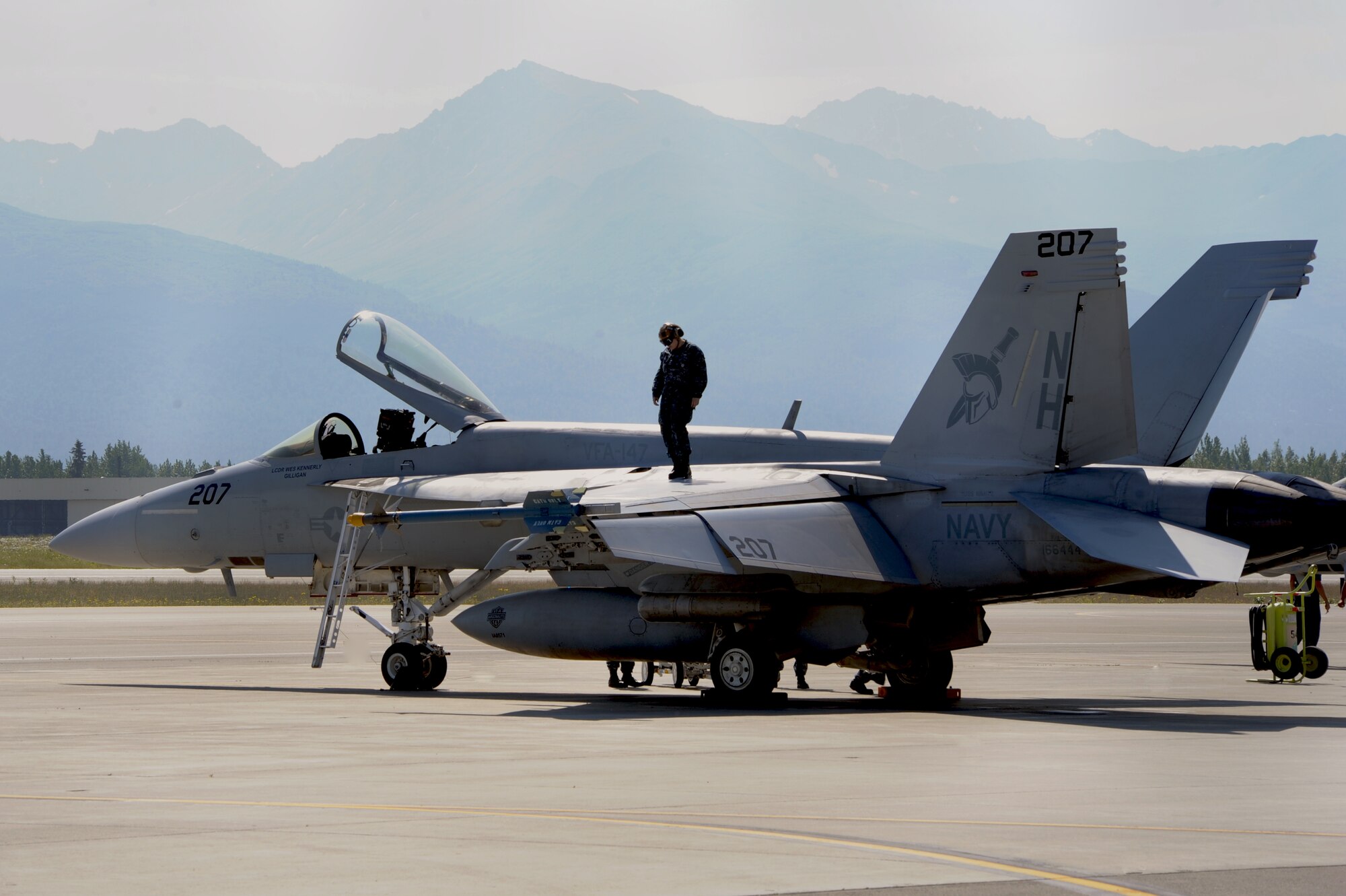 A crew member prepares a U.S. Navy F/A-18F Super Hornet from the Strike Fighter Squadron 147, Naval Air Station Lemoore, Calif., after it returned from a mission during Exercise Northern Edge 15 from Joint Base Elmendorf-Richardson, June 17, 2015. Northern Edge 15 is Alaska’s premier joint training exercise designed to practice operations, techniques and procedures as well as enhance interoperability among the services. Thousands of participants from all services, from active duty, Reserve and National Guard units, are involved. (U.S. Air Force photo/Staff Sgt. William Banton)‪