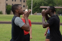 Airman 1st Class Tyler Walker, left, 47th Civil Engineer Squadron firefighter apprentice, competes against Senior Airman DiJohn Lester, right, Medical Operations Squadron bioenvironmental engineering technician, in an egg balancing race on Laughlin Air Force Base, Texas, June 13, 2015. Laughlin dorm residents formed teams to compete in various events in attempt to take home first place and win prizes. (U.S. Air Force photo by Airman 1st Class Brandon May)