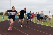 Airmen compete in a 400 meter relay race on Laughlin Air Force Base, Texas, June 13, 2015. The 400 meter relay was one of many events that made up Laughlin’s first ever Dorm Olympics. Dorm residents formed teams of four to compete for prizes. (U.S. Air Force photo by Airman 1st Class Brandon May)
