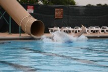 An Airman sees how far he can slide across the water at the Friendship Pool on Laughlin Air Force Base, Texas, June 13, 2015. This event was one of many that were part of Laughlin’s first ever Dorm Olympics, where Senior Airman and below formed teams of four to see who came out on top. (U.S. Air Force photo by Airman 1st Class Brandon May)