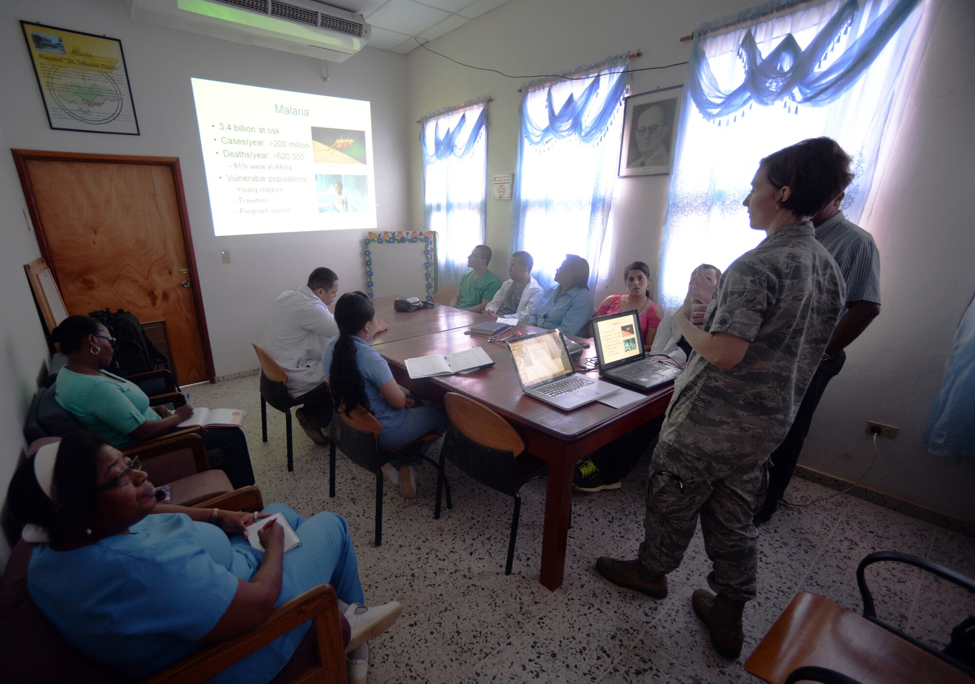 U.S. Air Force Maj. Charla Tully, Defense Institute for Medical Operations, infectious disease physician, Air Force Medial Support Agency, out of Joint Base San Antonio-Lackland, Texas, and Elk City, Okla., teaches doctors at the Dr. Salvador Paredes Hospital about malaria with translation assistance by Dr. Miguel Coello, Medical Element medical officer, Joint Task Force Bravo, out of Soto Cano Air Force Base, Honduras, and Tegucigalpa, Honduras native, in Trujillo, Honduras, June 17, 2015. Tully and Coello are part of vector-borne surveillance team working alongside the Honduran Ministry of Health in an effort to eradicate malaria in the Colón region of Honduras which is part of the New Horizons Honduras 2015 training exercise taking place throughout Tocoa and Trujillo. New Horizons was launched in the 1980s and is an annual joint humanitarian assistance exercise that U.S. Southern Command conducts with a partner nation in Central America, South America or the Caribbean. The exercise improves joint training readiness of U.S. and partner nation civil engineers, medical professionals and support personnel through humanitarian assistance activities. (U.S. Air Force photo by Capt. David J. Murphy/Released)