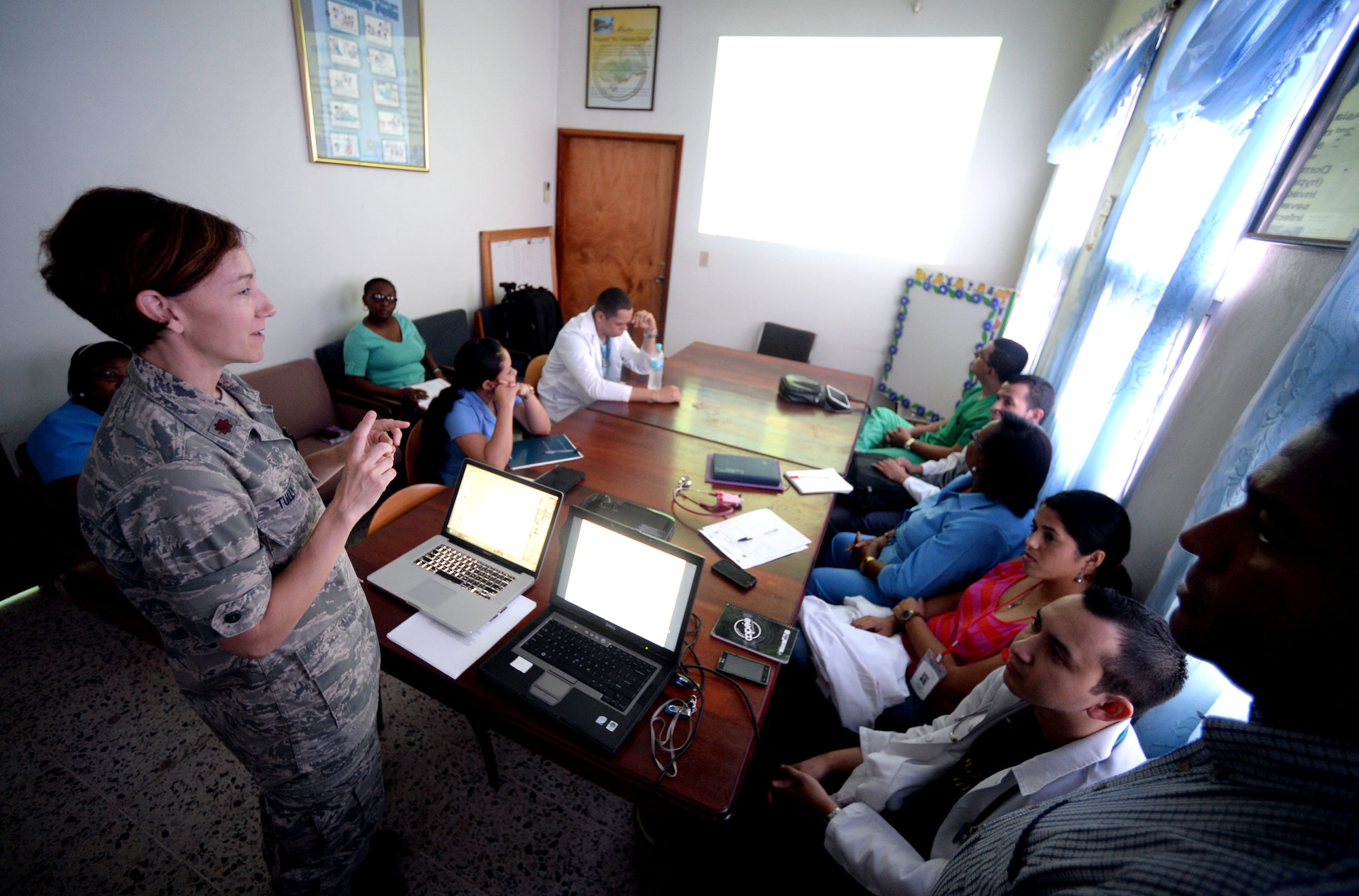 U.S. Air Force Maj. Charla Tully, Defense Institute for Medical Operations, infectious disease physician, Air Force Medial Support Agency, out of Joint Base San Antonio-Lackland, Texas, and Elk City, Okla., teaches doctors at the Dr. Salvador Paredes Hospital about malaria with translation assistance by Dr. Miguel Coello, Medical Element medical officer, Joint Task Force Bravo, out of Soto Cano Air Force Base, Honduras, and Tegucigalpa, Honduras native, in Trujillo, Honduras, June 17, 2015. Tully and Coello are part of vector-borne surveillance team working alongside the Honduran Ministry of Health in an effort to eradicate malaria in the Colón region of Honduras which is part of the New Horizons Honduras 2015 training exercise taking place throughout Tocoa and Trujillo. New Horizons was launched in the 1980s and is an annual joint humanitarian assistance exercise that U.S. Southern Command conducts with a partner nation in Central America, South America or the Caribbean. The exercise improves joint training readiness of U.S. and partner nation civil engineers, medical professionals and support personnel through humanitarian assistance activities. (U.S. Air Force photo by Capt. David J. Murphy/Released)
