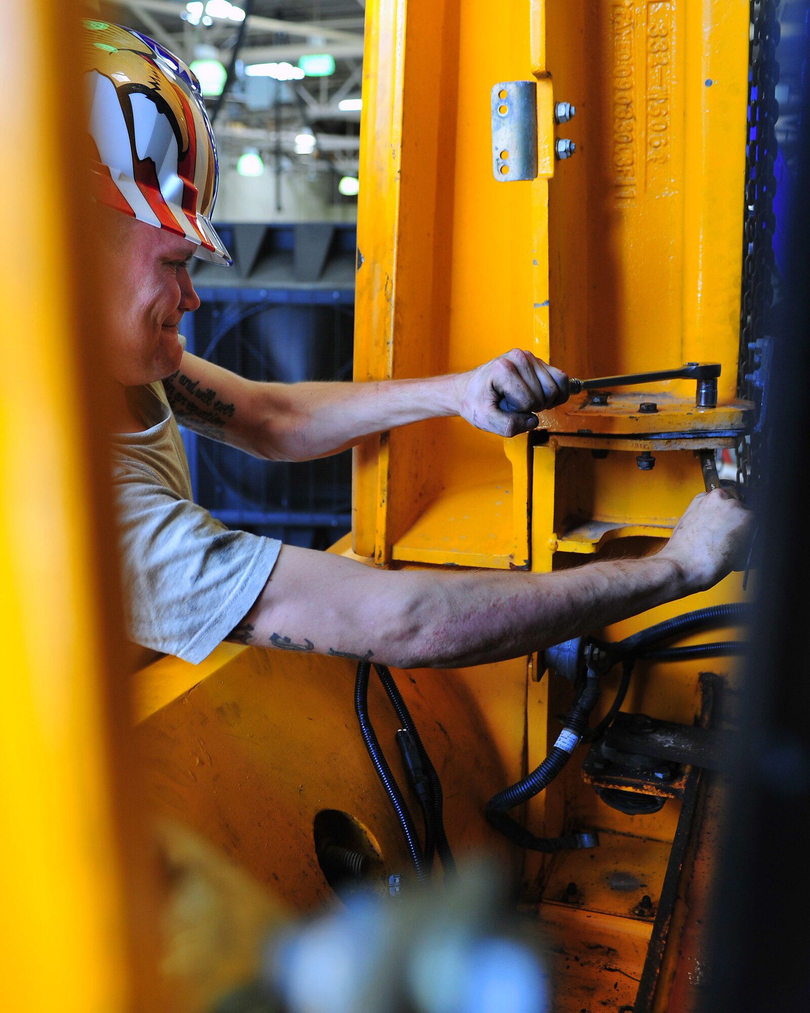 Senior Airman Chris Morel, 4th Logistics Readiness Squadron vehicle maintenance technician, performs maintenance on an MB-4 tow tractor, June 15, 2015, at Seymour Johnson Air Force Base, North Carolina. The vehicle management section supports 24 units throughout the base by servicing government vehicles. (U.S. Air Force photo/Senior Airman John Nieves Camacho)