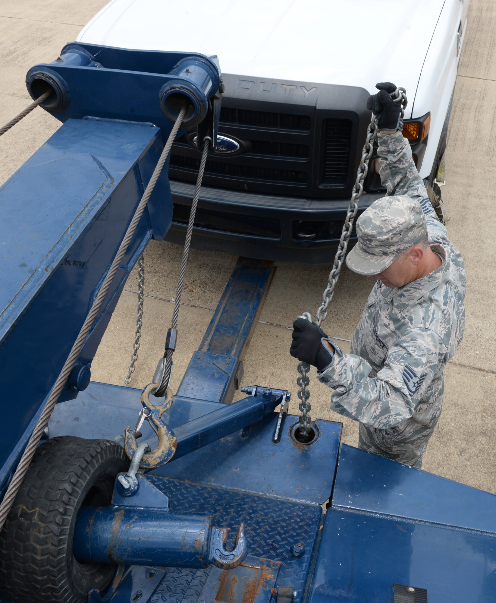 Tech. Sgt. James Baggott, 403rd Logistics Readiness Squadron vehicle control officer from Keesler Air Force Base, Miss., secures a pickup truck to a 20-ton wrecker on Barksdale Air Force Base, La., June 12, 2015. Baggott was one of five reserve Airmen to come to Barksdale for two weeks as part of an annual tour for training with the 2nd LRS vehicle operations Airmen. (U.S. Air Force photo/Airman 1st Class Curt Beach)