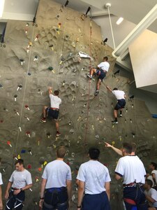 As part of an "Amazing Race" style event, 20 U.S. Air Force Academy and Reserve Officers' Training Corps cadets ran to Outdoor Recreation June 15, 2015 at Joint Base Charleston, S.C., where the cadets partnered up and took turns on the rock wall, challenging themselves and using teamwork to ensure everyone made it to the top. The cadets also visited the Heritage Park where Stan Gohl, the 437th Airlift Wing historian briefed the group on the history of the 437th AW and the three static jets that reside in the air park and Combat Arms Training and Maintenance where they handled weapons ranging from the M-9 pistol to a .50 Cal Sniper Rifle. During each stop, the Airman's Creed was incorporated into the visit and what the creed means to the enlisted personnel. The cadets are visiting JB Charleston as part of Operation Air Force, which exposes them to a real-world Air Force environment and provides them the opportunity to see how base components work together to meet the mission. This is the first of three groups scheduled to visit the base. (U.S. Air Force photo / Capt. Brian Walker)   
