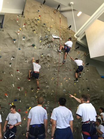 As part of an "Amazing Race" style event, 20 U.S. Air Force Academy and Reserve Officers' Training Corps cadets ran to Outdoor Recreation June 15, 2015 at Joint Base Charleston, S.C., where the cadets partnered up and took turns on the rock wall, challenging themselves and using teamwork to ensure everyone made it to the top. The cadets also visited the Heritage Park where Stan Gohl, the 437th Airlift Wing historian briefed the group on the history of the 437th AW and the three static jets that reside in the air park and Combat Arms Training and Maintenance where they handled weapons ranging from the M-9 pistol to a .50 Cal Sniper Rifle. During each stop, the Airman's Creed was incorporated into the visit and what the creed means to the enlisted personnel. The cadets are visiting JB Charleston as part of Operation Air Force, which exposes them to a real-world Air Force environment and provides them the opportunity to see how base components work together to meet the mission. This is the first of three groups scheduled to visit the base. (U.S. Air Force photo / Capt. Brian Walker)   

