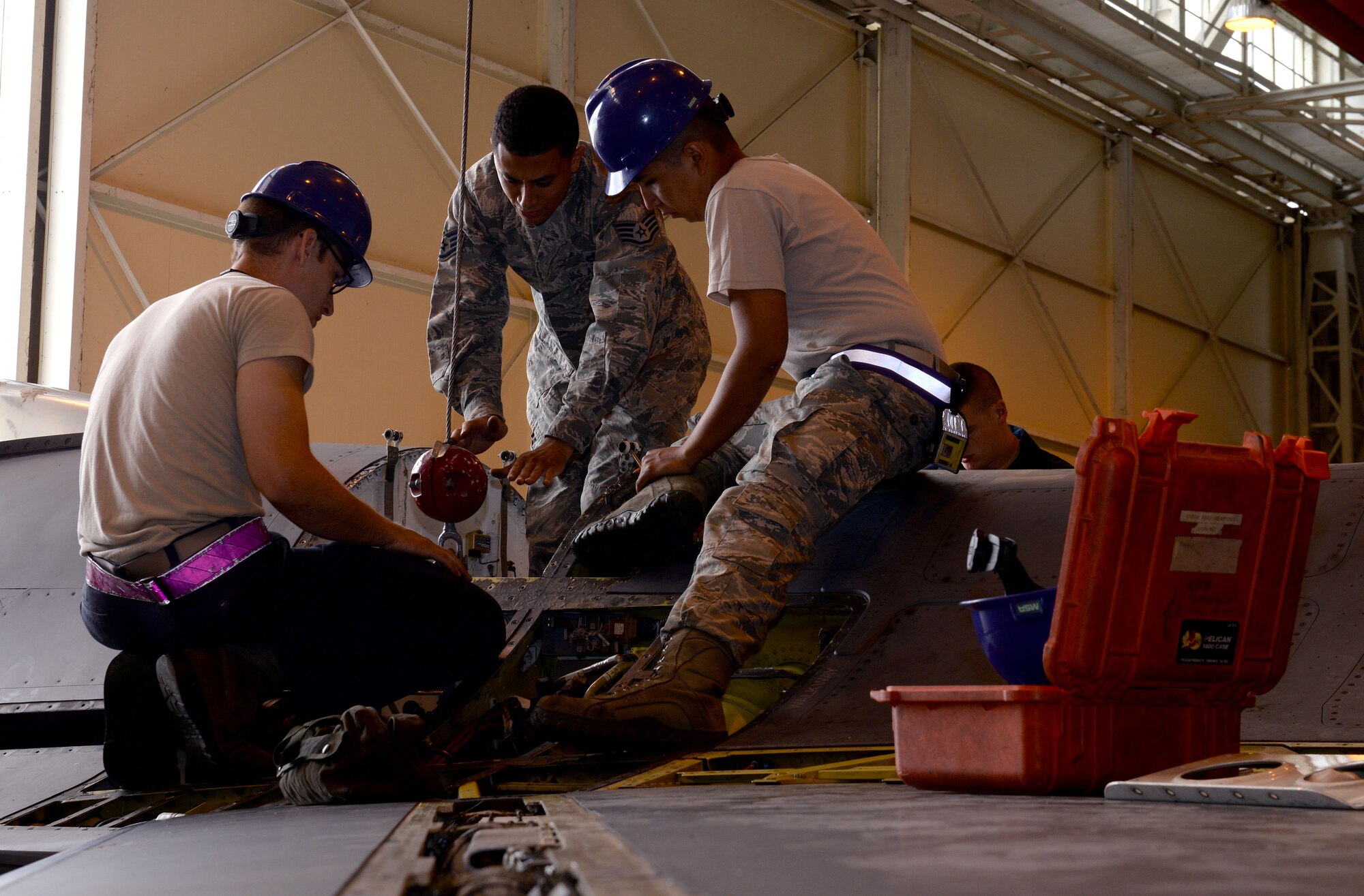 U.S. Air Force Airmen from the 31st Aircraft Maintenance Squadron prepare to lift a gun drum from an F-16 Fight Falcon’s gun bay during a phase inspection, June 15, 2015, at Aviano Air Base, Italy. The gun bay section received its 18-month extended inspection along with general maintenance. (U.S. Air Force Airman 1st Class Cary Smith/Released)