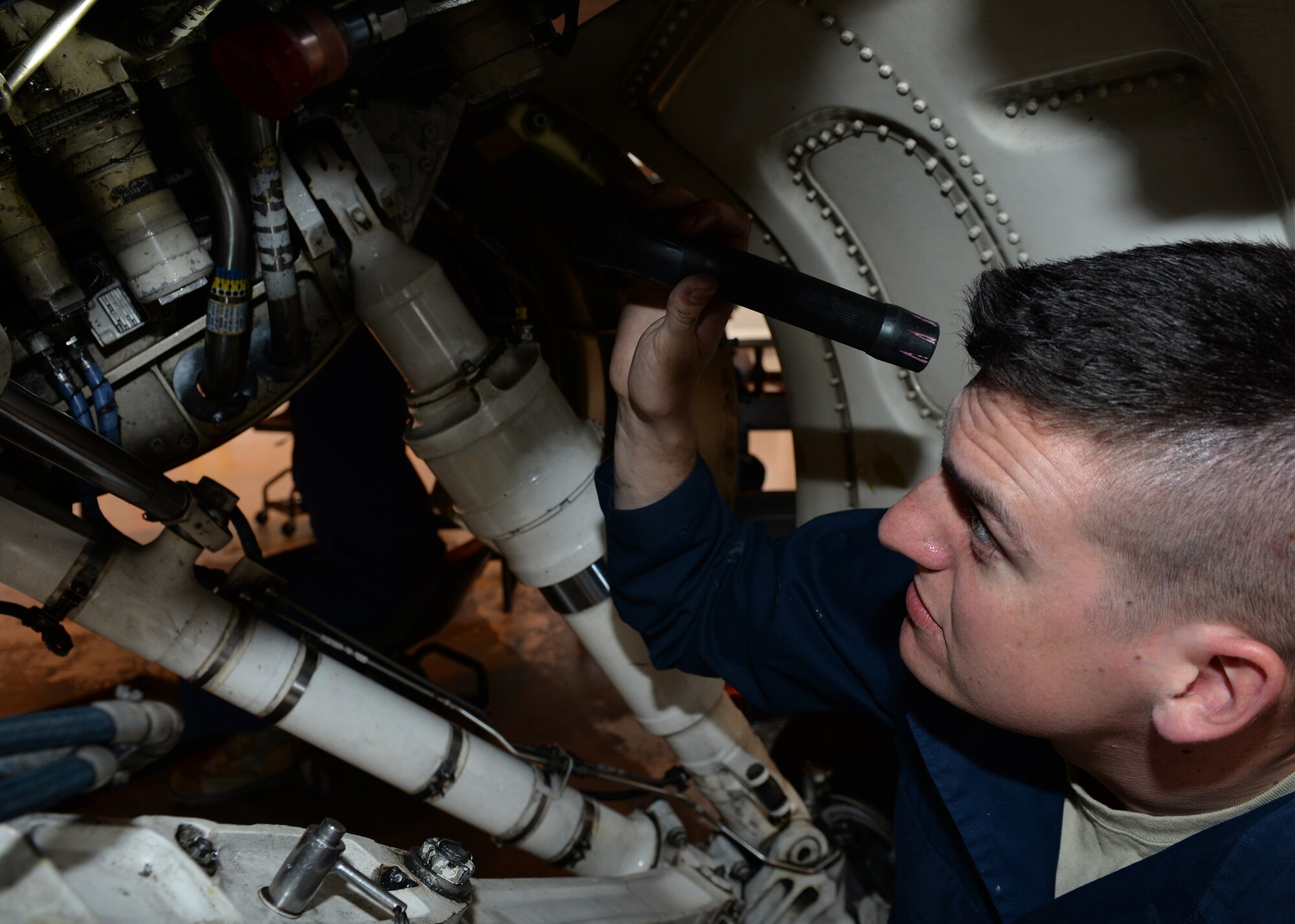 U.S. Air Force Airmen 1st Class Andrew Kasperski, 31st Aircraft Maintenance Squadron phase technicians, checks for cracks in the bulk head during a phase inspection of an F-16 Fighting Falcon, June 15, 2015, at Aviano Air Base, Italy. Phase Airmen are assigned specific section of the aircraft to ensure it is thoroughly inspected. (U.S. Air Force Airman 1st Class Cary Smith/Released)