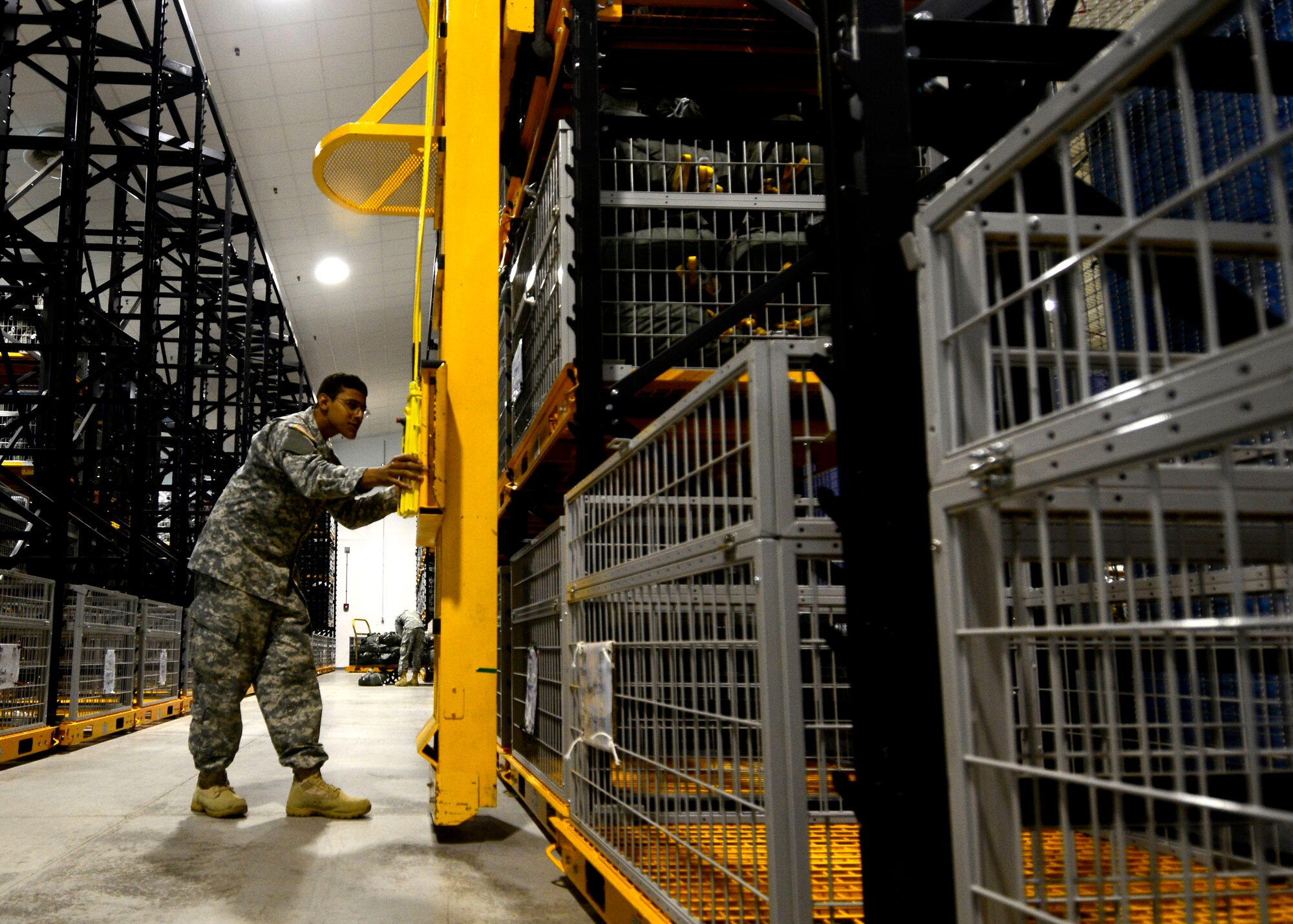 U.S. Army Spc. Mario Vallejo, Headquarters and Headquarters Company 173rd Brigade Support Battalion parachute packer, stores parachutes, June 17, 2015, at Aviano Air Base, Italy. In addition to packing, riggers perform regular maintenance and repairs on parachutes. (U.S. Air Force photo by Senior Airman Areca T. Wilson/Released)