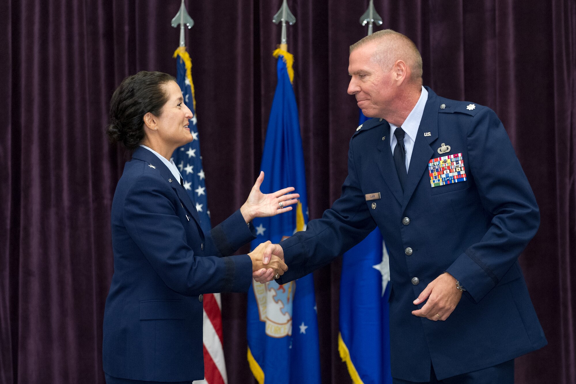 Brig. Gen. Nina Armagno, 45th Space Wing commander,  congratulates Lt. Col. Steven Clark, incoming 45th Comptroller Squadron commander, during a change of command ceremony June 15, 2015, at Patrick Air Force Base, Fla. Changes of command are a military tradition representing the transfer of responsibilities from the presiding officials to the upcoming official. (U.S. Air Force photo/Cory Long) (Released)