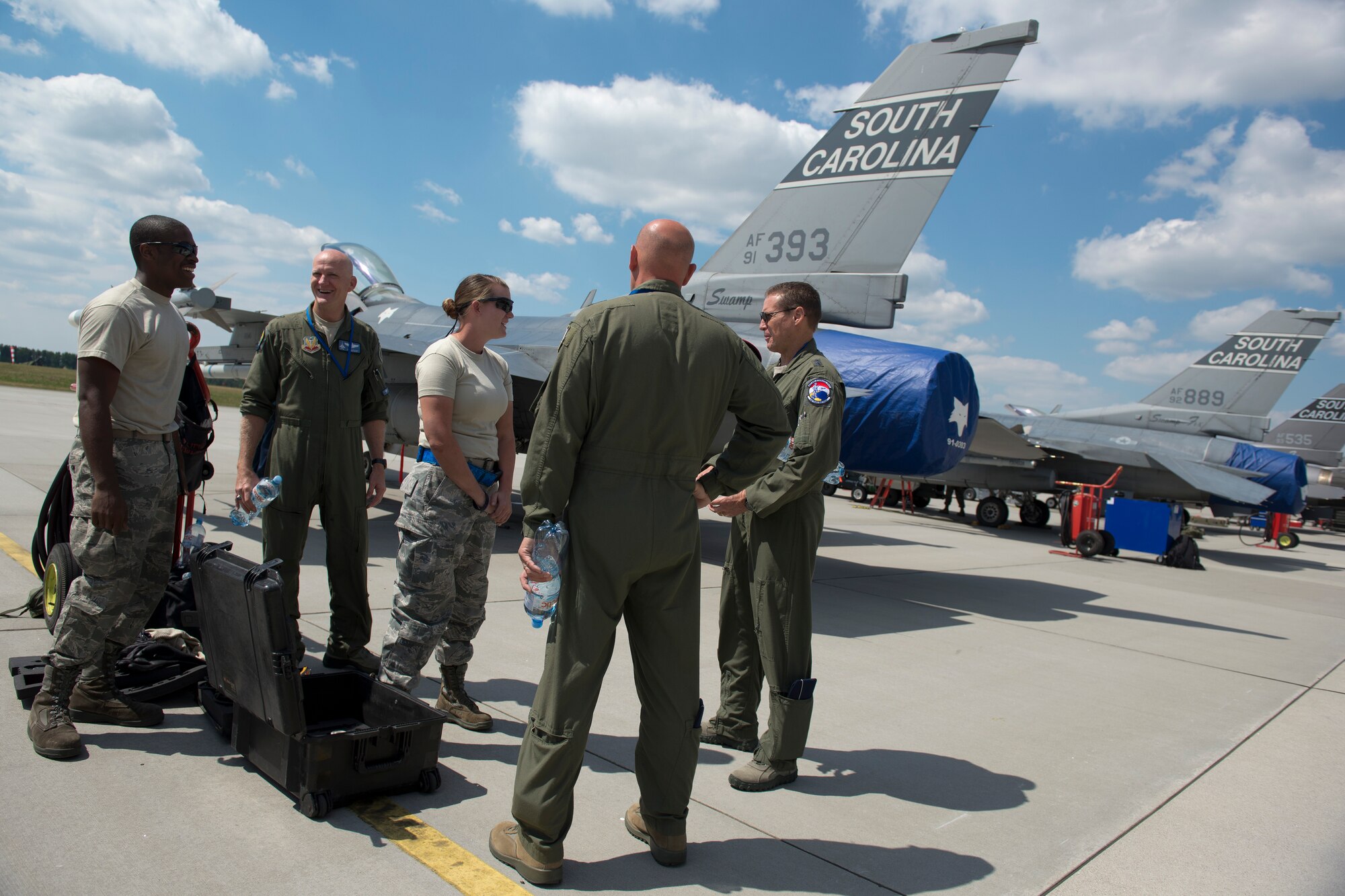 Airmen take a break to talk with leadership from the U.S. Air National Guard at Łask Air Base, Poland, June 11, 2015. Airmen from the 480th Fighter Squadron, Spangdahlem AB, Germany, and 169th Fighter Wing, South Carolina Air National Guard, are deployed to Łask AB in support of the F-16 Aviation detachment rotation. The AVDET is an opportunity for total force Airmen to hone their skills in a forward location while participating in bi-lateral training with a key ally, Poland. (U.S. Air Force photo/Tech. Sgt. Paul Villanueva II)