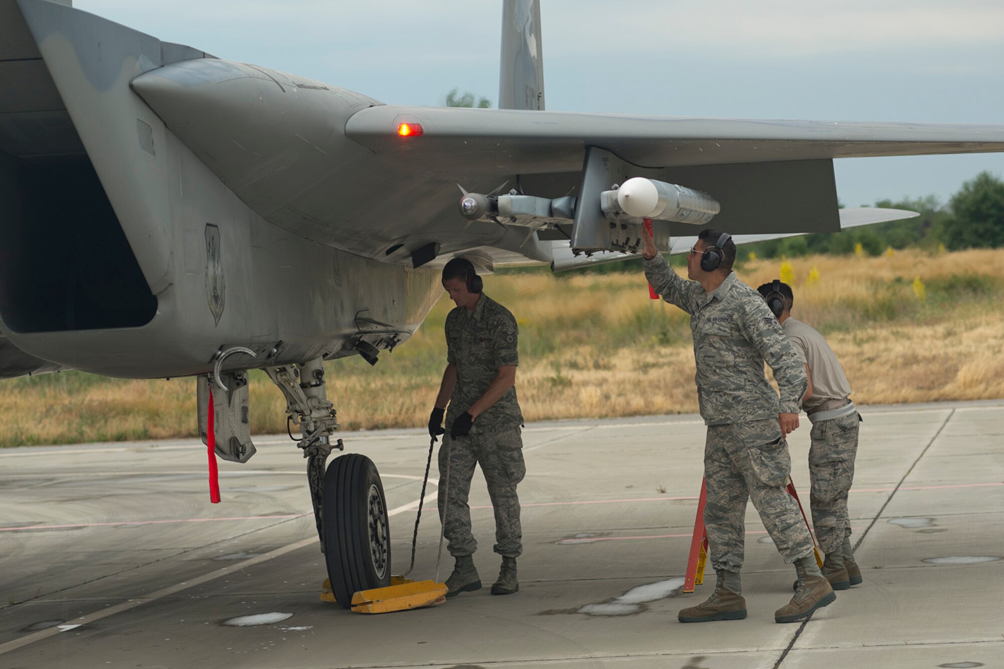 U.S Air Force Staff Sgt. Jerin Shumway, 142nd Maintenance Squadron F-15 crew chief, Oregon Air National Guard, left, and Senior Airman Cesar Cordero, a 125th Maintenance Squadron aircraft armament specialist, Florida ANG, perform final checks on an F-15 Strike Eagle before it takes off from Graf Ignatievo Air Base, Bulgaria, June 10, 2015. The Airmen are deployed to the 159th Expeditionary Fighter Squadron in support of the theater security package. The combined efforts of the total force Airmen help maintain a global presence and strengthen relationships with NATO allies through various training scenarios. (U.S. Air Force photo/Tech. Sgt. Paul Villanueva II)