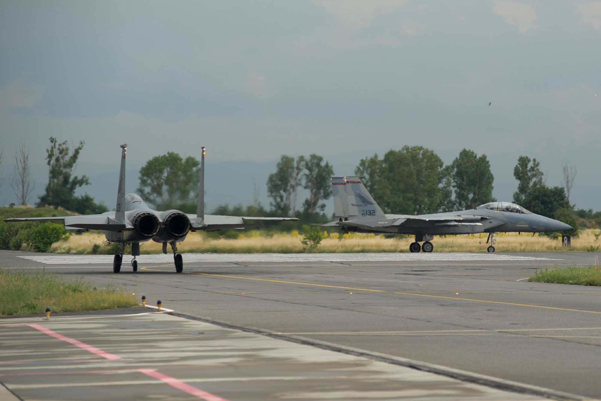 An F-15 Strike Eagle from the 125th Fighter Wing, Florida Air National Guard, and an F-15 from the 142 FW, Oregon ANG, prepare to takeoff at Graf Ignatievo Air Base, Bulgaria, June 10, 2015.  The F-15s are deployed to Graf Ignatievo AB in support of the theater security package. The combined efforts of the Total force Airmen help maintain a global presence and strengthen relationships with NATO allies through these various training scenarios. (U.S. Air Force photo/Tech. Sgt. Paul Villanueva II)