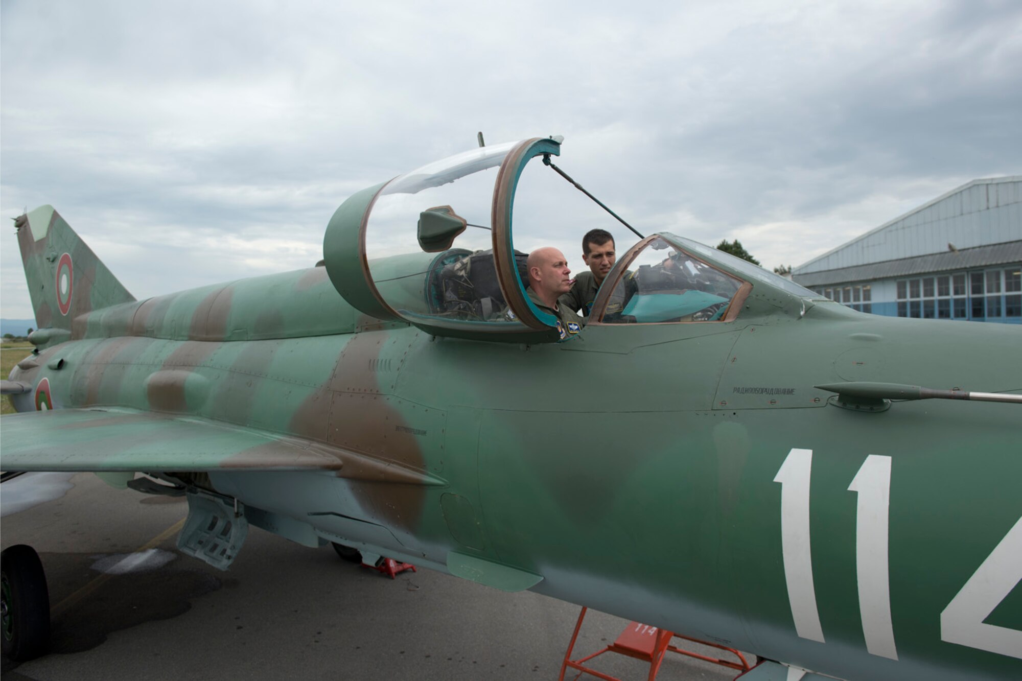 U.S. Air Force Maj. Gen. Eric W. Vollmecke sits in a Bulgarian MiG-21 as Bulgarian air force 1st Lt. Aleksandar Staykov explains the capabilities of the aircraft at Graf Ignatievo Air Base, Bulgaria, June 9, 2015. Vollmecke, Air National Guard mobilization assistant to the commander for United States Air Forces in Europe-Air Forces Africa, is visiting with active duty and ANG Airmen deployed to the 159th Expeditionary Fighter Squadron in support of the theater security package. The combined efforts of the total force Airmen help maintain a global presence and strengthen relationships with NATO allies through various training scenarios. (U.S. Air Force photo/Tech. Sgt. Paul Villanueva II)