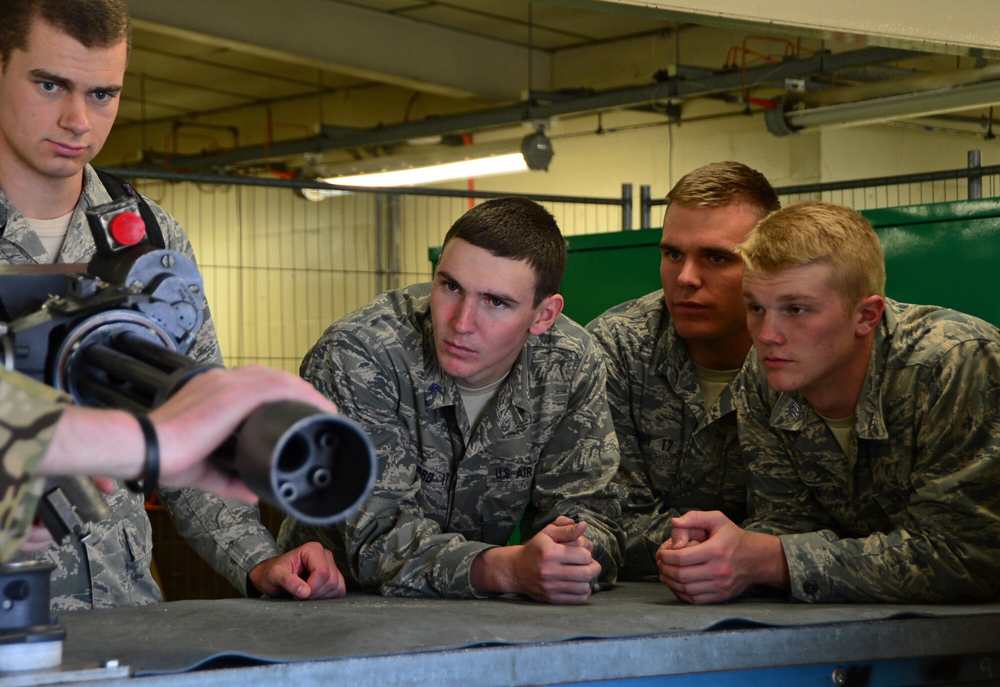 A group of Air Force Academy cadets observe a weapon demonstration from 56th Rescue Squadron personnel during a tour at Royal Air Force Lakenheath, England, June 10, 2015. Base tours serve as a way for cadets to broaden their knowledge about the Air Force mission and operations, both overseas and stateside. (U.S. Air Force photo by Senior Airman Erin O’Shea/Released)  