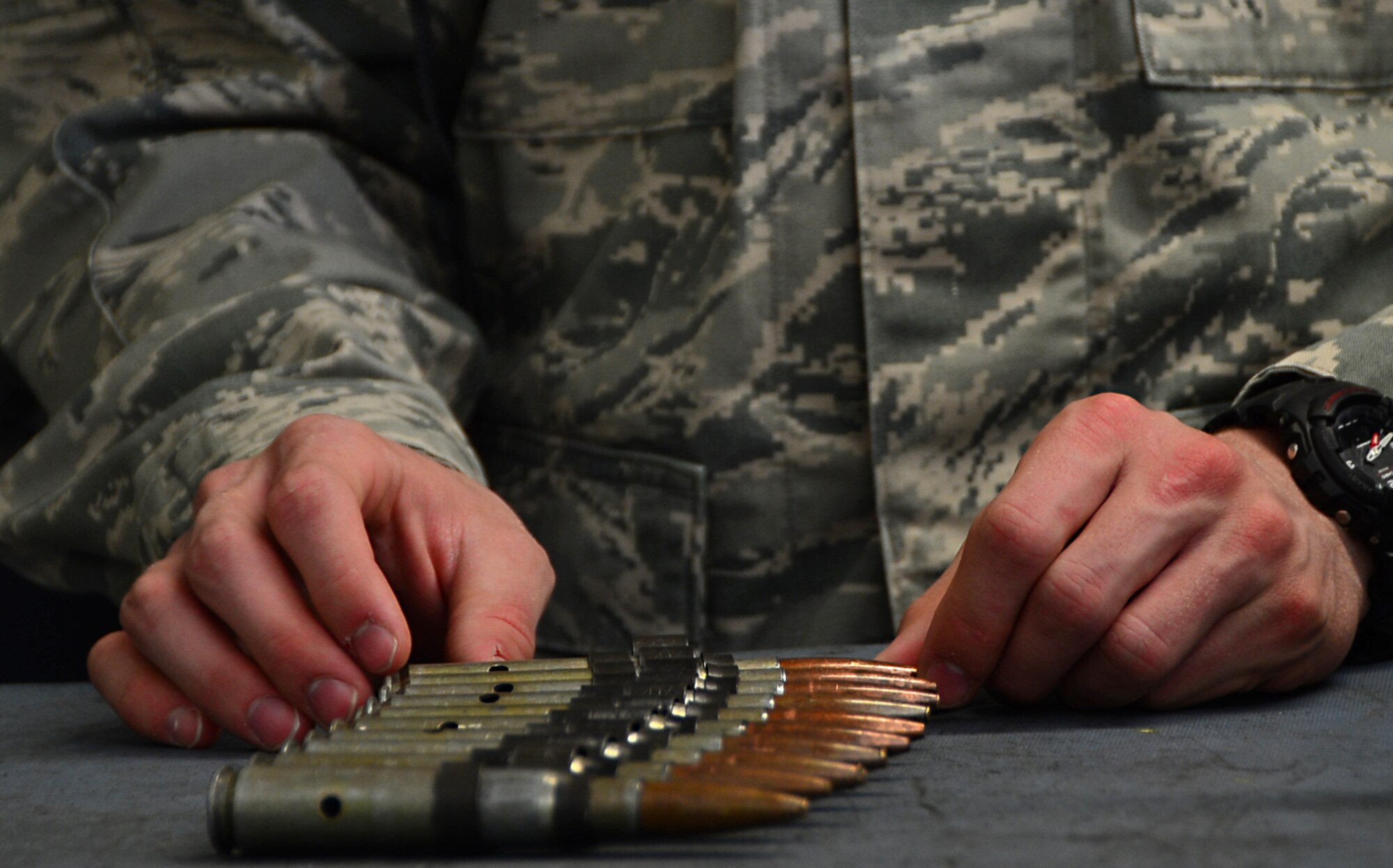 A U.S. Air Force Academy cadet observes .50-caliber machine gun ammunition during a tour at Royal Air Force Lakenheath, England, June 10, 2015. Base tours serve as an outlet for cadets to broaden their knowledge about the Air Force mission and operations, both overseas and stateside. (U.S. Air Force photo by Senior Airman Erin O’Shea/Released)  