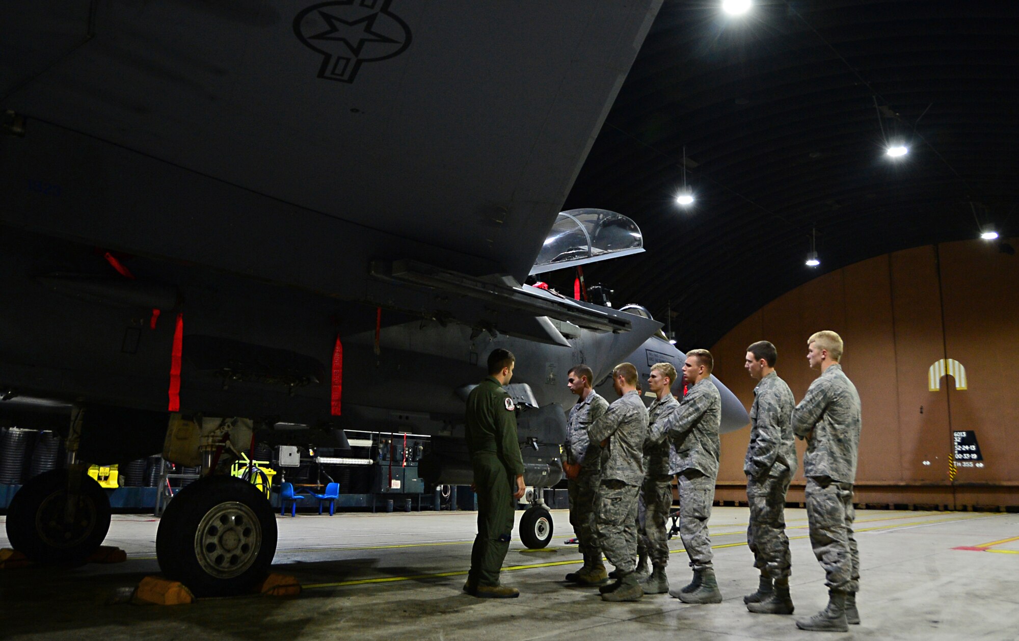 1st Lt. Paul Carpenter, 494th Fighter Squadron F-15E Strike Eagle pilot, explains aircraft capabilities to a group of U.S. Air Force Academy cadets during a tour at Royal Air Force Lakenheath, England, June 10, 2015. The cadets visited RAF’s Lakenheath and Mildenhall to learn about each bases mission capabilities and various unit responsibilities. (U.S. Air Force photo by Senior Airman Erin O’Shea/Released)
