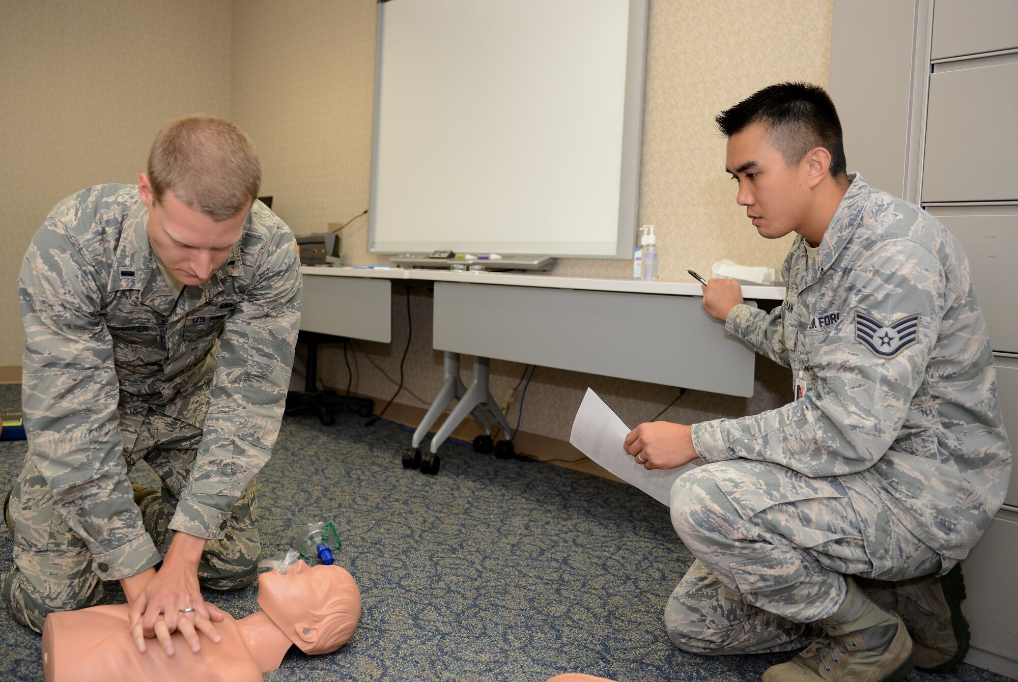 1st Lt. Corey Rotschaffer, 36th Wing Staff Agency assistant staff judge advocate, administers chest compressions during a Heartsaver CPR training course June 12, 2015, at Andersen Air Force Base, Guam. The 36th Medical Group education and training section offers courses to provide the most accurate and up-to-date lifesaving practices for members. (U.S. Air Force photo by Airman 1st Class Arielle Vasquez/Released)