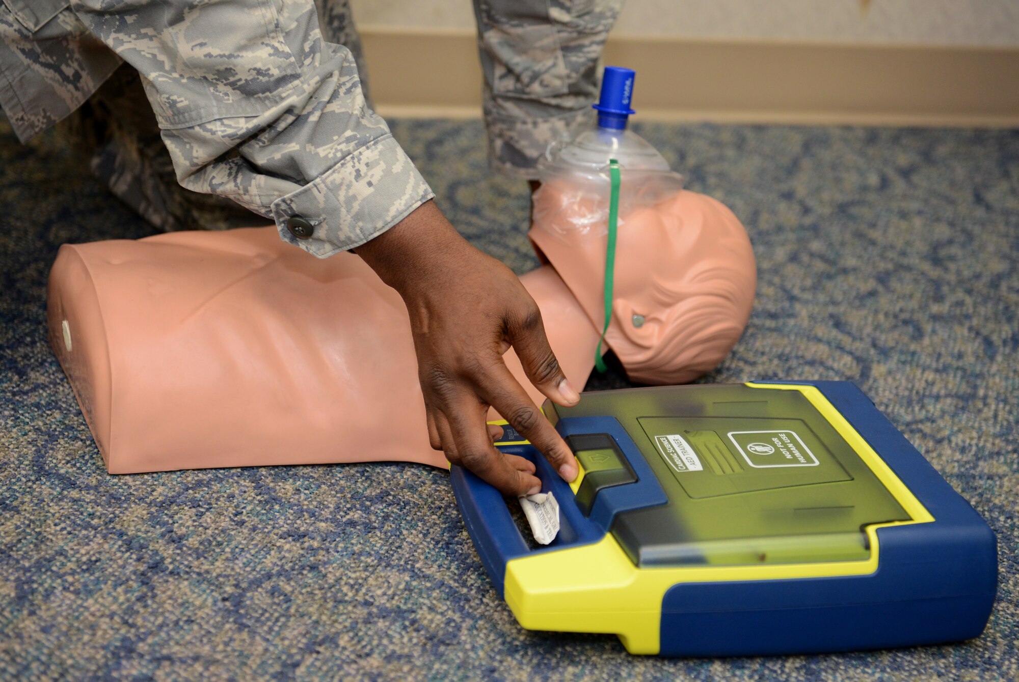 Airman 1st Class Stephen Haynes, 36th CPTS Financial Management Flight technician, practices using a defibrillator during a Heartsaver CPR training course June 12, 2015, at Andersen Air Force Base, Guam. The 36th Medical Group education and training section offers courses to provide the most accurate and up-to-date lifesaving practices for members. (U.S. Air Force photo by Airman 1st Class Arielle Vasquez/Released)