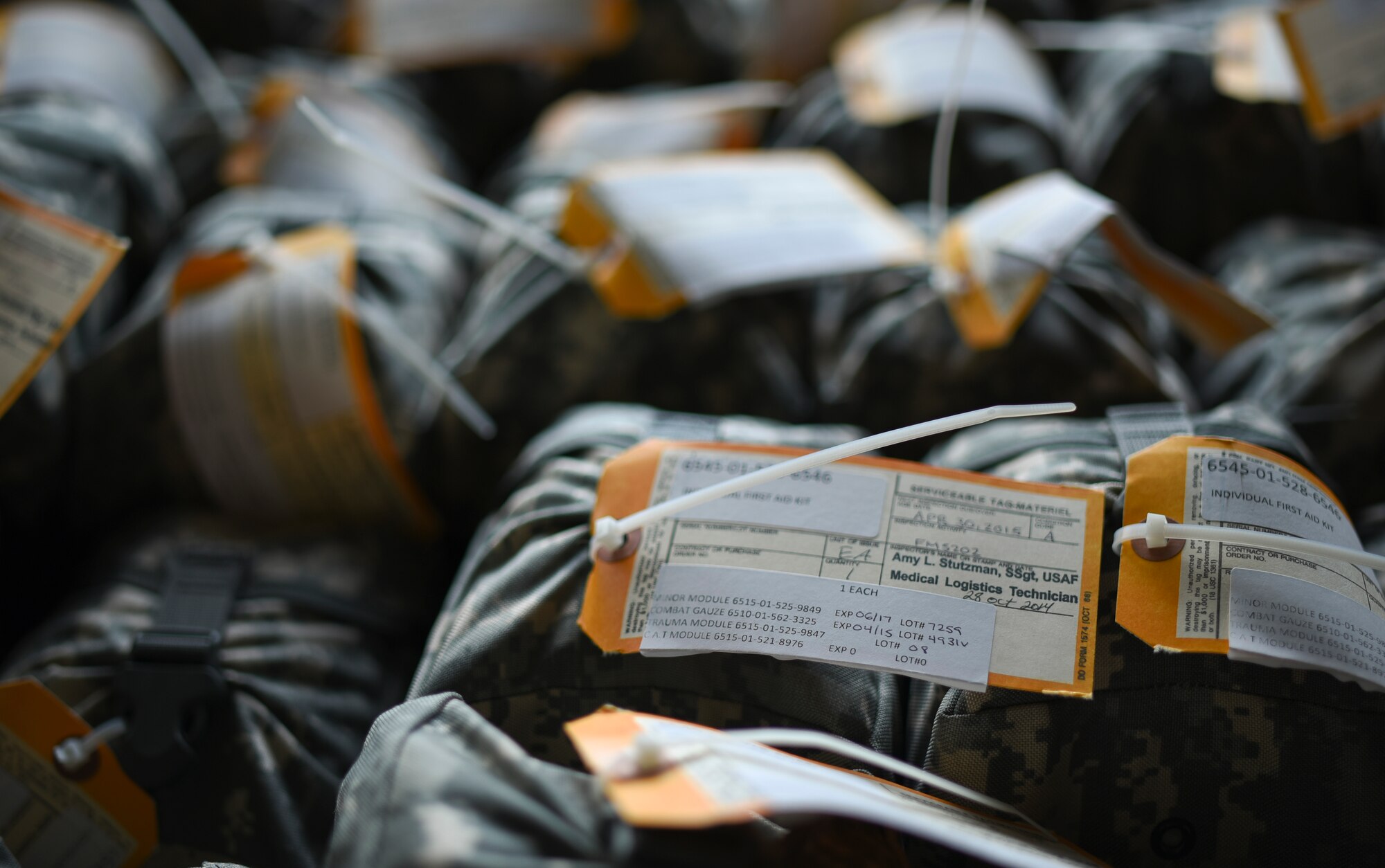 Expired individual first aid kits sit in a container inside the individual protective equipment warehouse at Yokota Air Base, Japan, June 15, 2015. Individual first aid kits contain a number of medical related items. If any of the items expire, the whole kit needs to be replaced. (U.S. Air Force photo by Senior Airman Michael Washburn/Released)