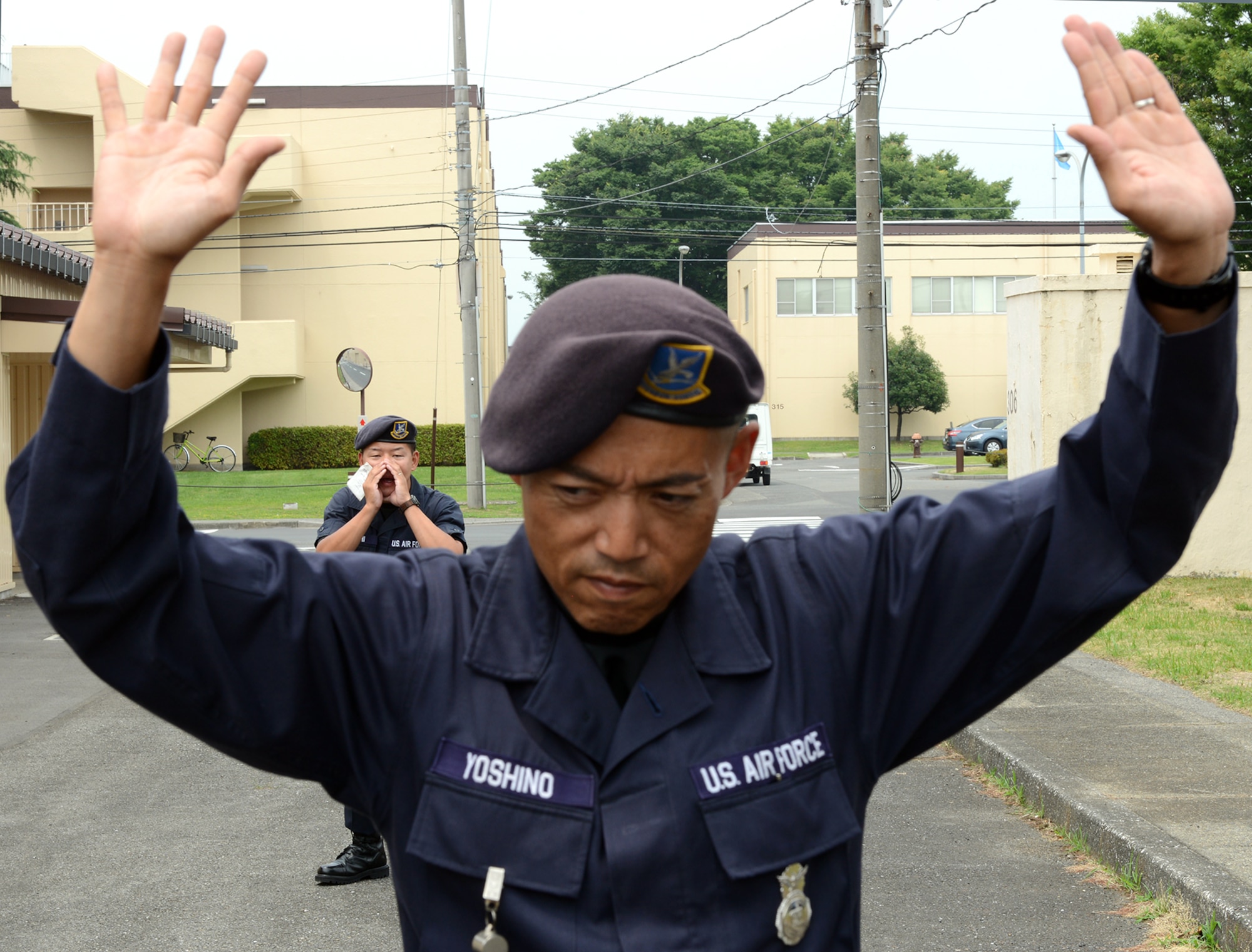 Yoshiyuki Yoshiko takes commands from fellow Security Forces guard Kenichiro Wachi during a training June 16, 2015, at Yokota Air Base, Japan. The 374th Security Forces Squadron conducts training daily to stay prepared to defend and maintain Yokota.  (U.S. Air Force photo by Senior Airman Desiree Economides/Released)
