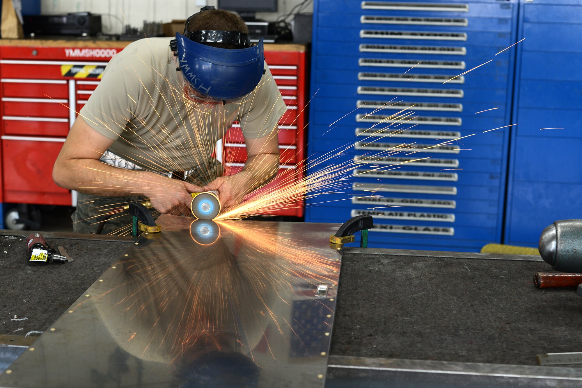 Airman 1st Class Jordan Pontius, 374th Maintenance Squadron aircraft structural maintainer, trims a steel cabinet door June 15, 2015, at Yokota Air Base, Japan. The door is a custom made project for the base hospital. (U.S. Air Force photo by Senior Airman Desiree Economides/Released)
