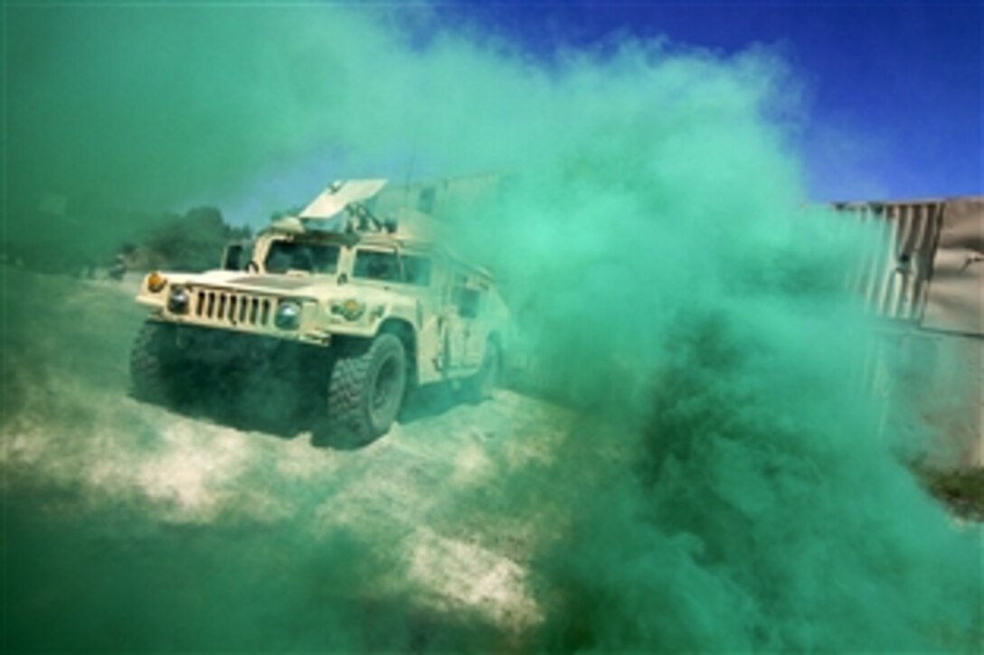 Smoke envelopes a Humvee during a leader exercise part of Operation Morning Coffee at Warren Grove Gunnery Range, N.J., June 17, 2015. The soldier is assigned to the New Jersey Air National Guard's 50th Infantry Brigade Combat Team.