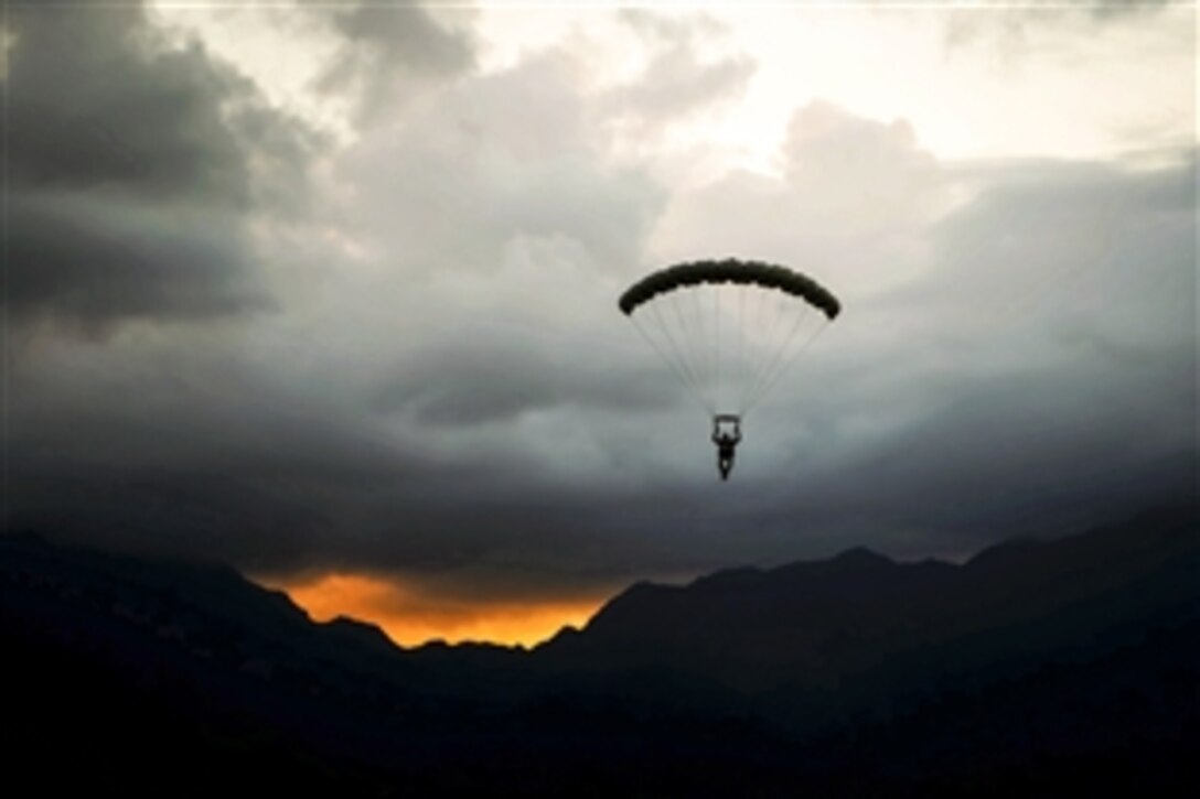 Marine Corps Gunnery Sgt. Eddie Myers parachutes from a UH-1Y Venom helicopter during insertion training on Marine Corps Air Station Kaneohe Bay, Hawaii, June 10, 2015. Myers is a parachute safety officer assigned to Detachment 4th Force Reconnaissance Company.