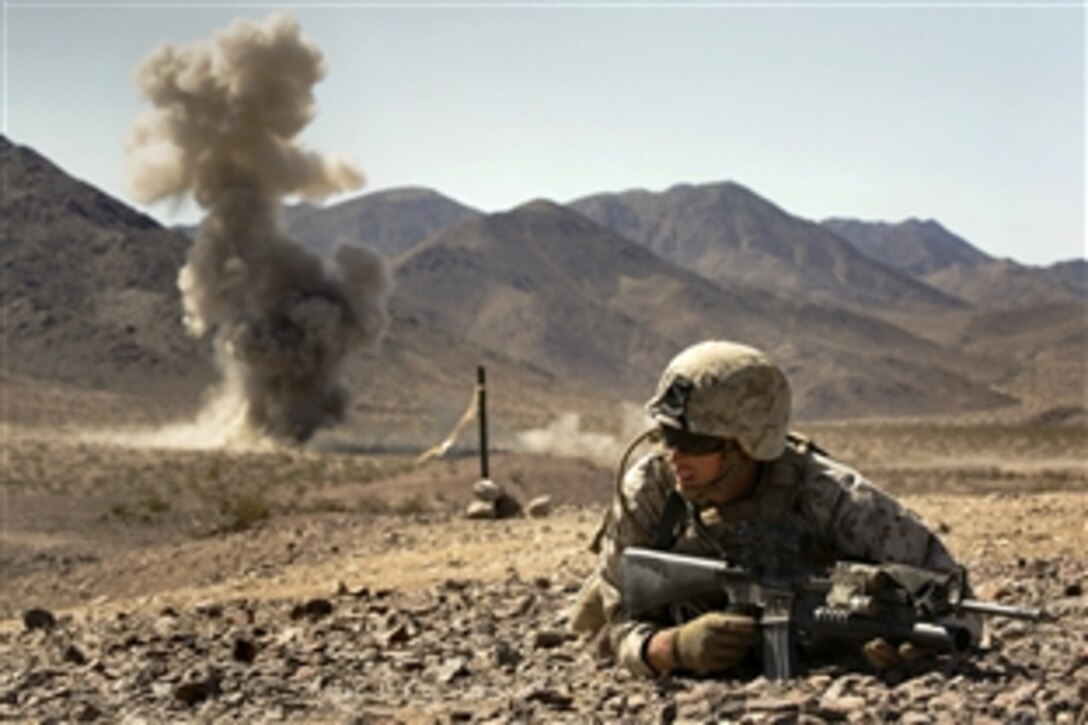Marine Corps Cpl. Colton Derick lays down for cover during a simulated enemy explosion during an integrated training exercise on Marine Corps Air Ground Combat Center Twentynine Palms, Calif., June 13, 2015. Derick is a rifleman assigned to the 4th Marine Division's Bravo Company, 1st Battalion, 23rd Marine Regiment, Marine Forces Reserve.