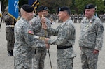 Symbolizing the passing of responsibility, Gen. Curtis M. Scaparrotti, commander, United Nations Command, Combined Forces Command and U.S. Forces Korea, passes the noncommissioned officer sword to Command Sgt. Maj. John W. Troxell (left), incoming command sergeant major, UNC/CFC/USFK, during a Oct. 7 change of responsibility ceremony at Knight Field.  Troxell assumed responsibility from Command Sgt. Maj. Anthony Mahoney (right), outgoing command sergeant major, UNC/CFC/USFK. First Sgt. Jose Santiago, United Nations Command Honor Guard (second from left) served as commander of troops.  (U.S. Army photo by Sgt. Brian Gibbons, U.S. Forces Korea PAO)