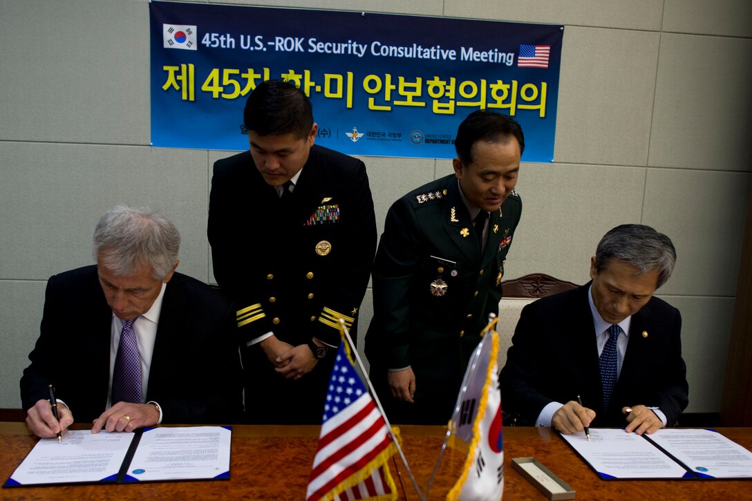 Secretary of Defense Chuck Hagel and Republic of Korea Minister of Defense Kim Kwan-jin sign a joint communique at the Ministry of Defense in Seoul October 2, 2013. Hagel met with with ROK Minister of Defense prior to the signing for the 45th security consultative meeting Photo by Erin A. Kirk-Cuomo (Released)