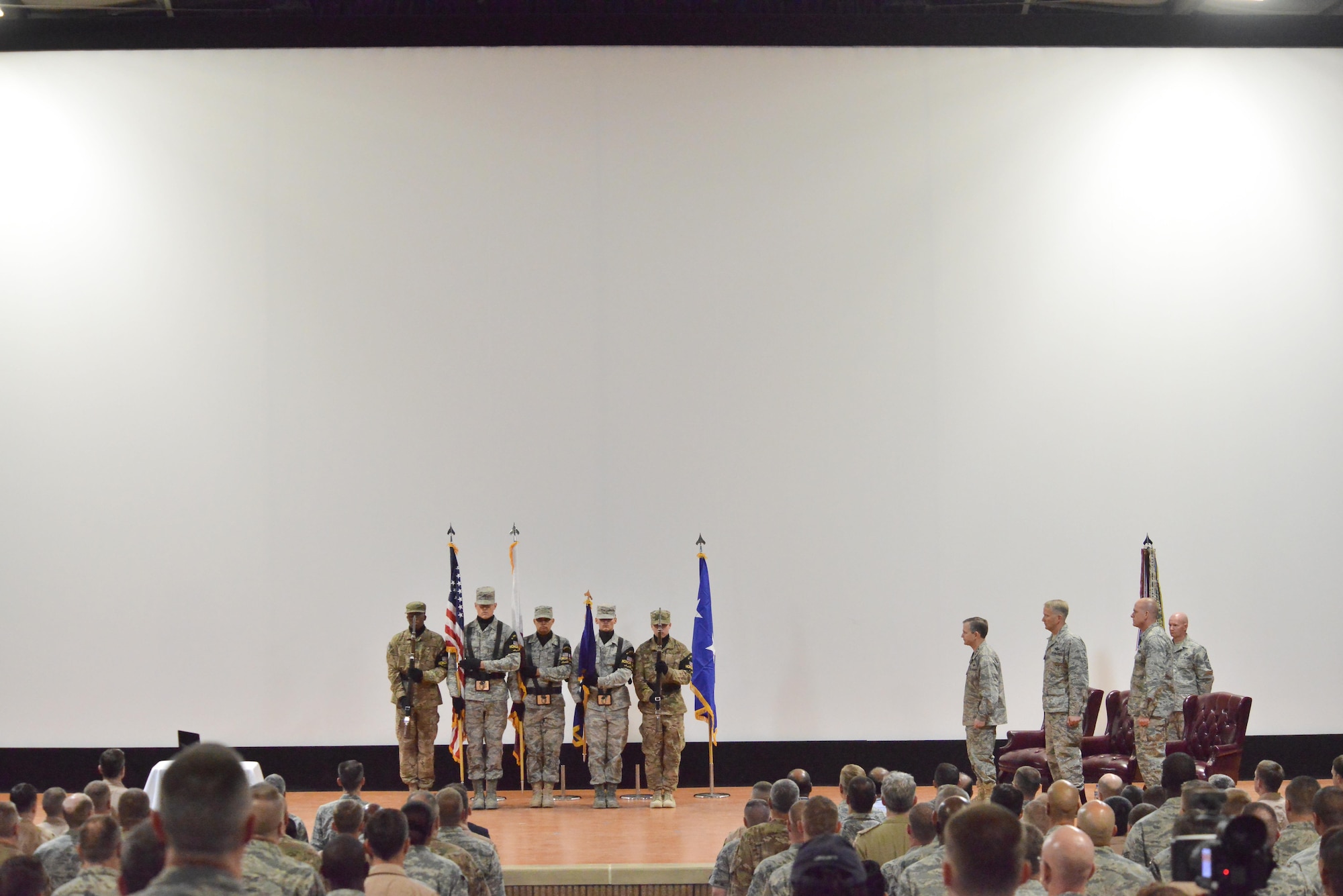 Al Udeid base honor presents the colors during the wing change of command ceremony June 14, 25015 Al Udeid Air Base, Qatar. Change of commands is a tradition that dates back to the Roman Legion in which authority is transferred from one commanding officer to another and is completed in front of the soldiers. (U.S. Air Force photo/Staff Sgt. Alexandre Montes)