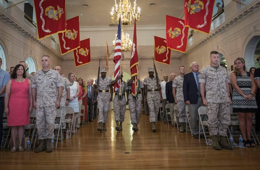BGen Kevin Killea (left) and BGen Julian Alford (right) stand at attention as the colors are marched on during the Marine Corps Warfighting Laboratory Change of Command Ceremony Thursday June 18, 2015.