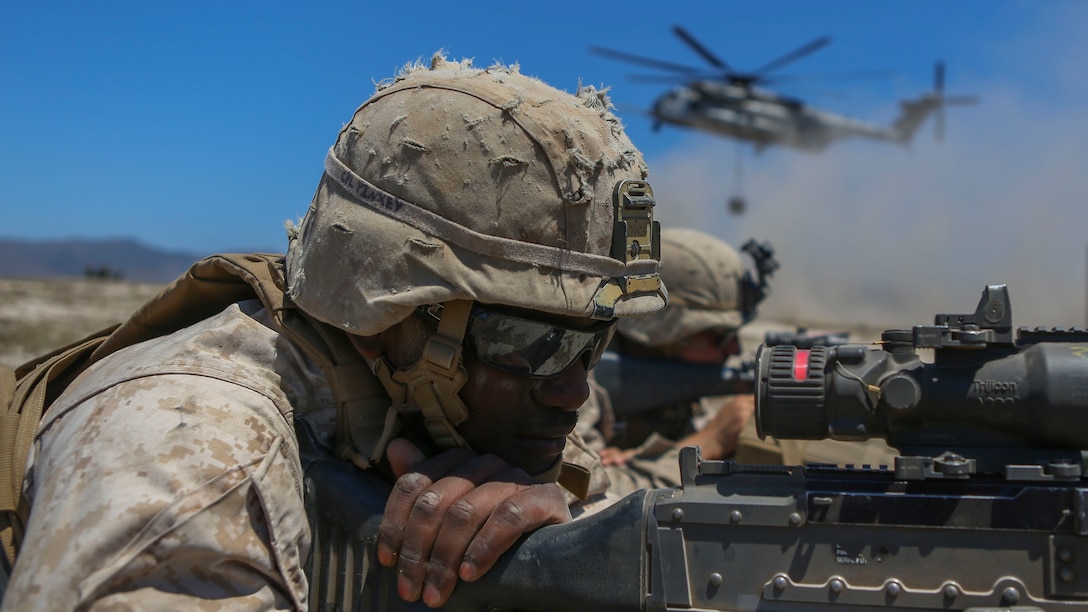 Corporal Kamen Pinkey, a motor transportation operator assigned to Company A, 1st Battalion, 11th Marine Regiment, 1st Marine Division, posts security for a CH-53E Super Stallion at Marine Corps Base Camp Pendleton, California, June 17, 2015. The CH-53s transported M777 howitzers and ammunition as part of 1/11’s quarterly exercise to test the artillery Marines’ proficiency and readiness.